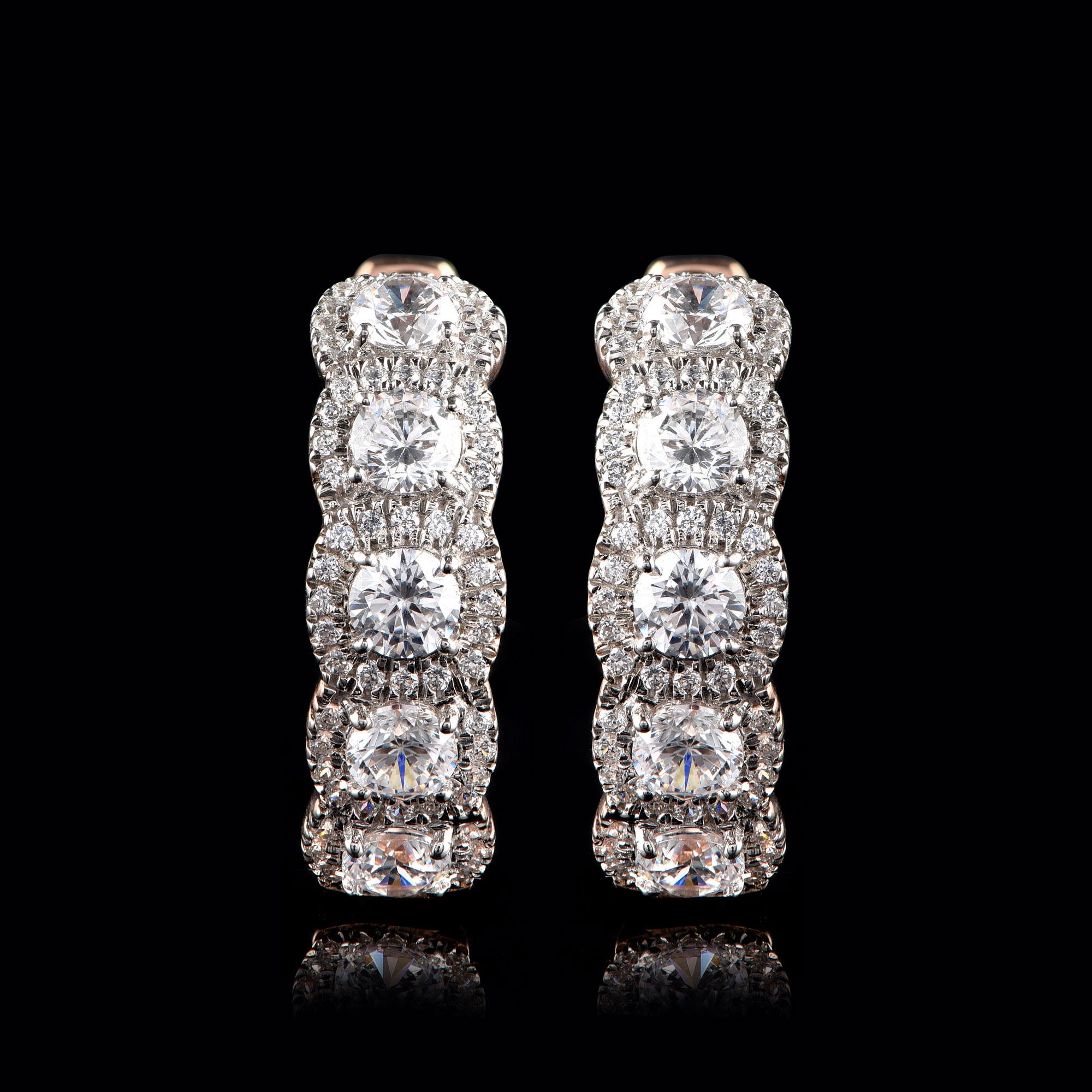These hoop earrings are studded with 130 brilliant-cut diamonds in micro-prong and prong setting and designed in 18-karat rose gold. The diamonds are graded H-I Color, I2 Clarity.