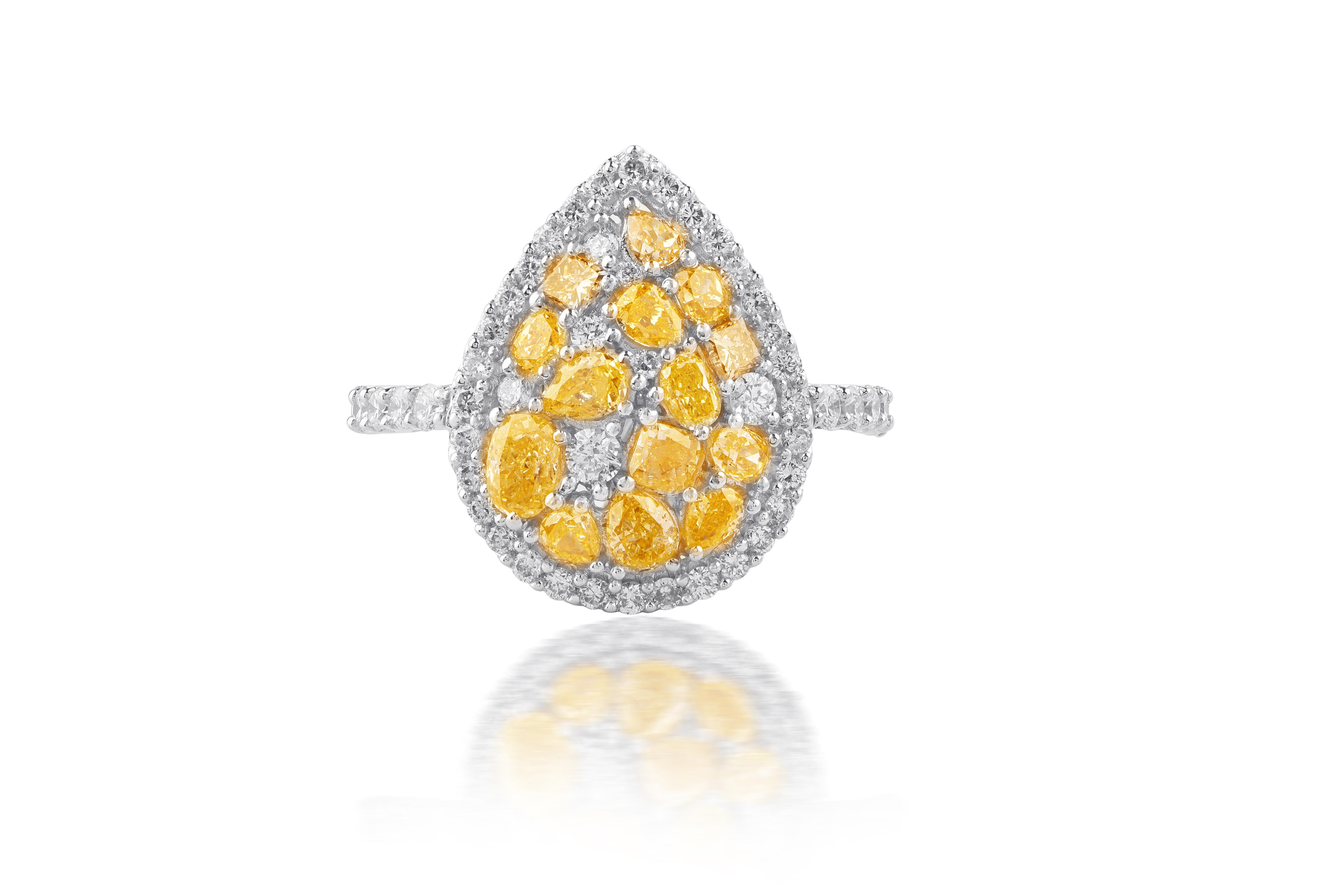 This gemstone ring makes a sparkling statement. Studded with 61 round diamonds including  Cushion, Pear and Oval Cut Lemon Diamonds and Princess Cut Brown Diamonds in prong setting and expertly crafted in 14 kt white gold. Diamonds are graded H-I