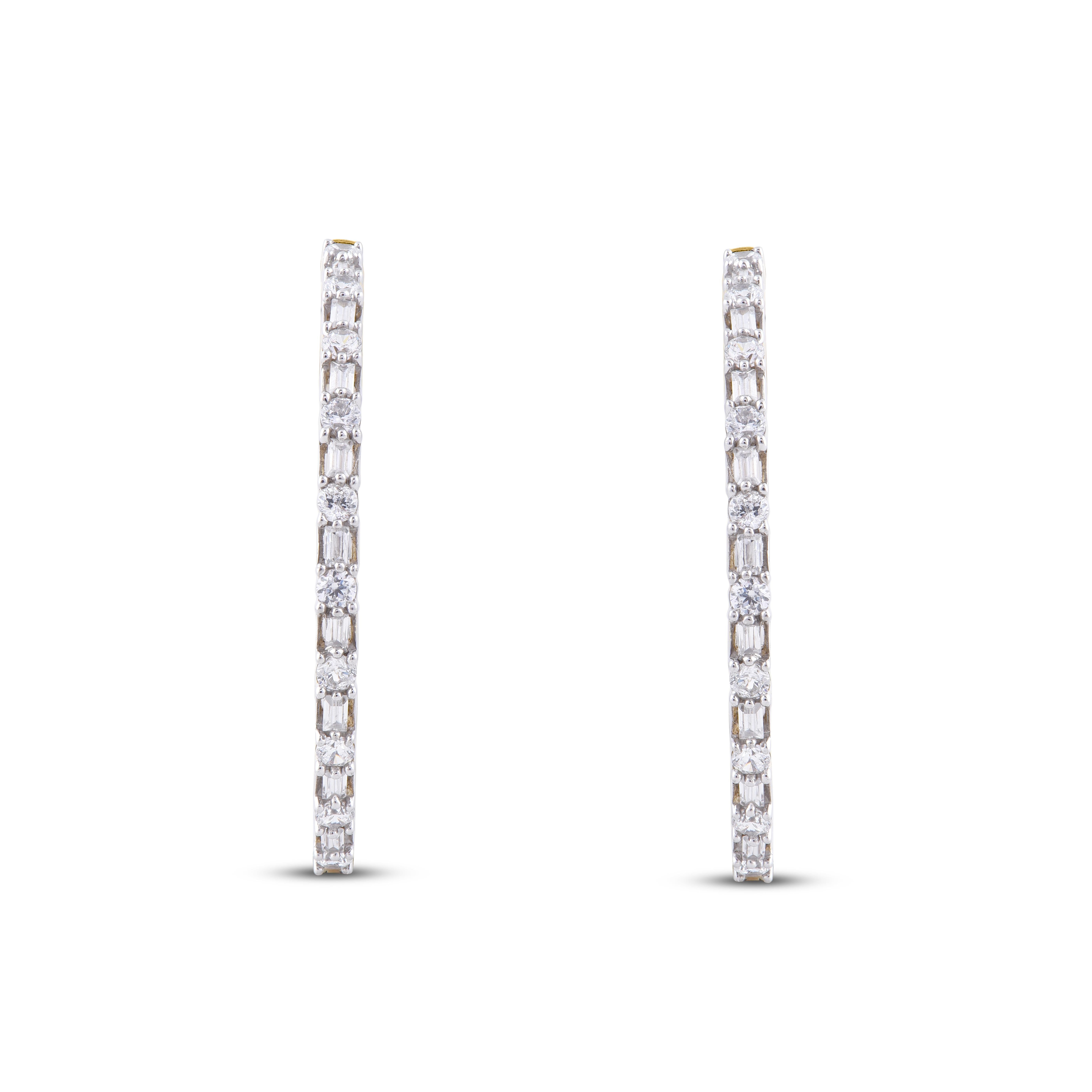 A sophisticated style, these diamond hoop earrings complement her attire. These earrings are done in 14 karat yellow gold with a 64 Baguette and 36 Round diamonds with H-I color I2 clarity.
