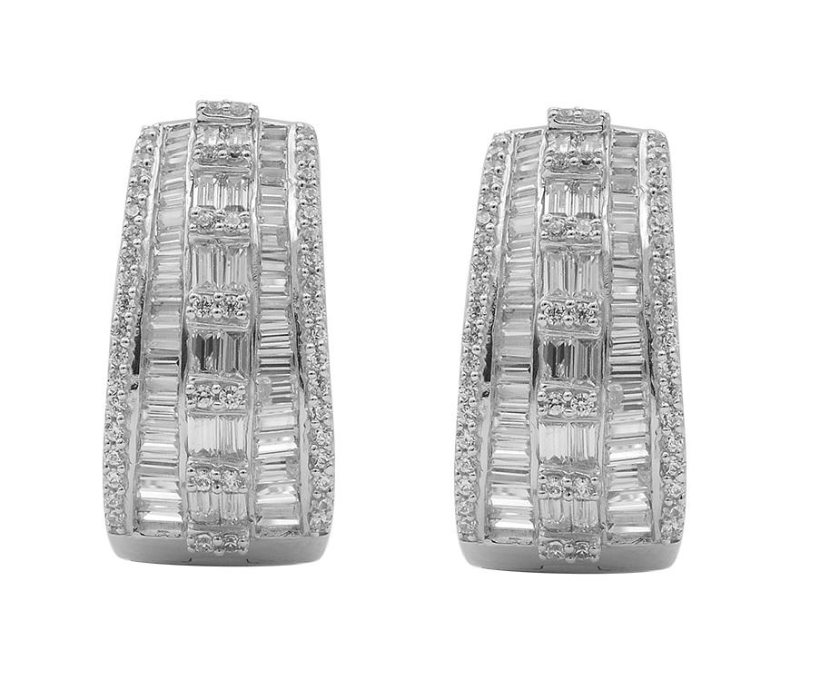 Just her style, these sparkling diamond huggie hoop earrings are certain to dazzle and delight. Handcrafted by our experts in 14 karat white gold and studded with 104 round brilliant and 92 baguette-cut diamond in prong and channel setting, glitters