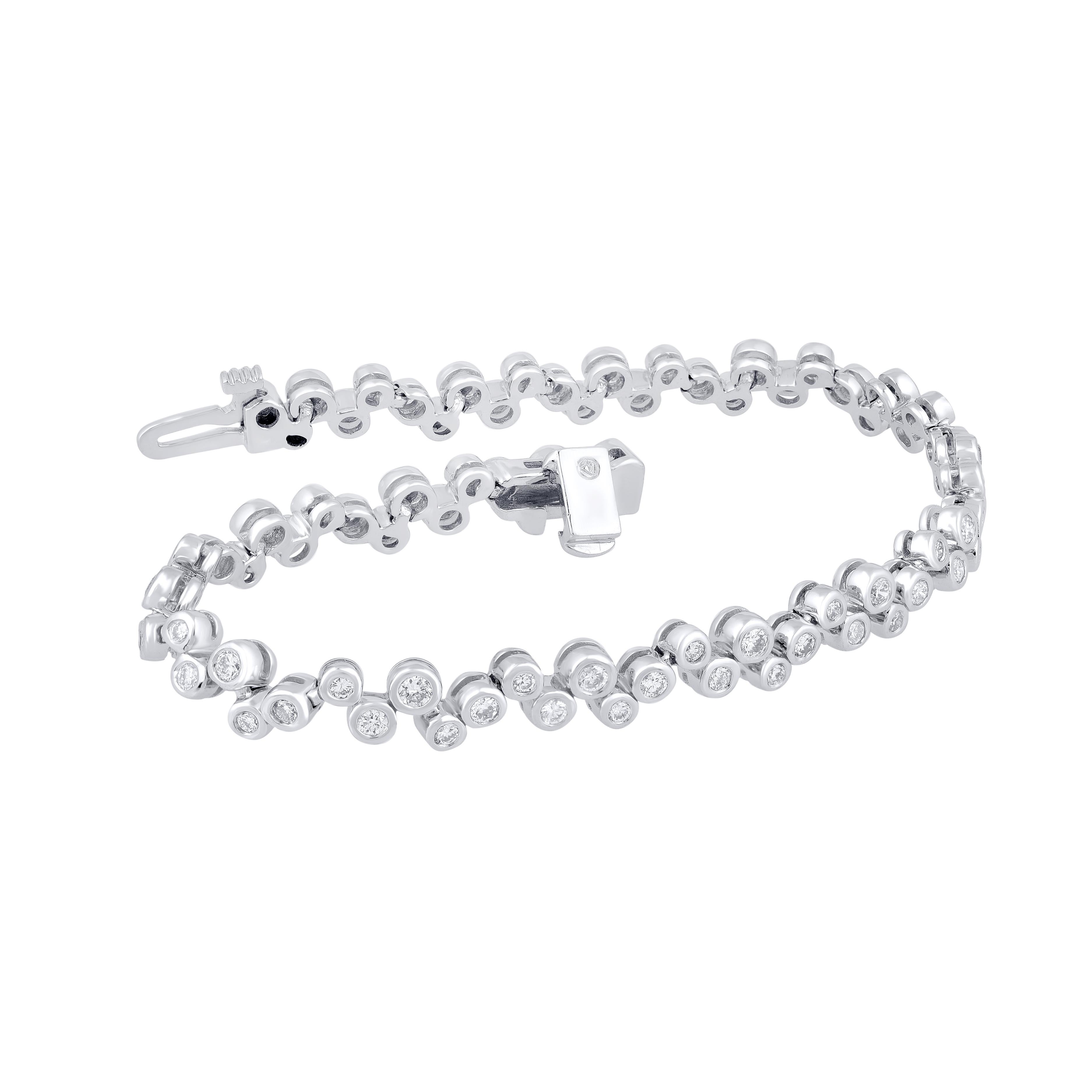 An elegantly designed designer bracelet for women, studded with 80 diamonds in Bezel setting The bracelet is beautifully crafted in 14 Kt white gold. Diamond details are graded GH Color, I1 Clarity. It secures firmly with Bracelet Catch. This