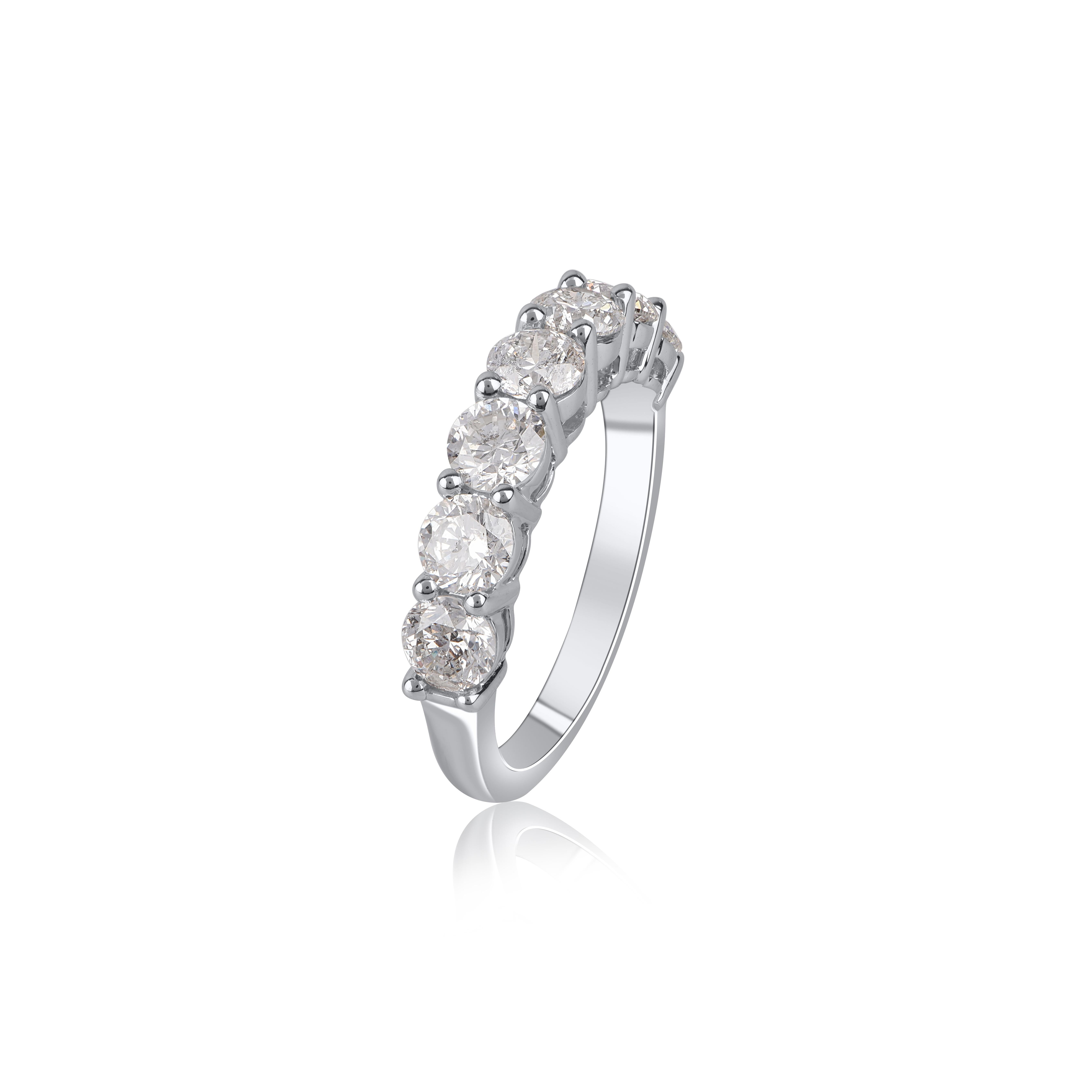 Crafted in 14 kt white gold and sparkling with 7 round-cut diamonds elegantly set in prong setting. The diamonds are graded H-I Color, I1 Clarity. This scintillating diamond wedding half eternity band will surely stand out. This ring will arrive in