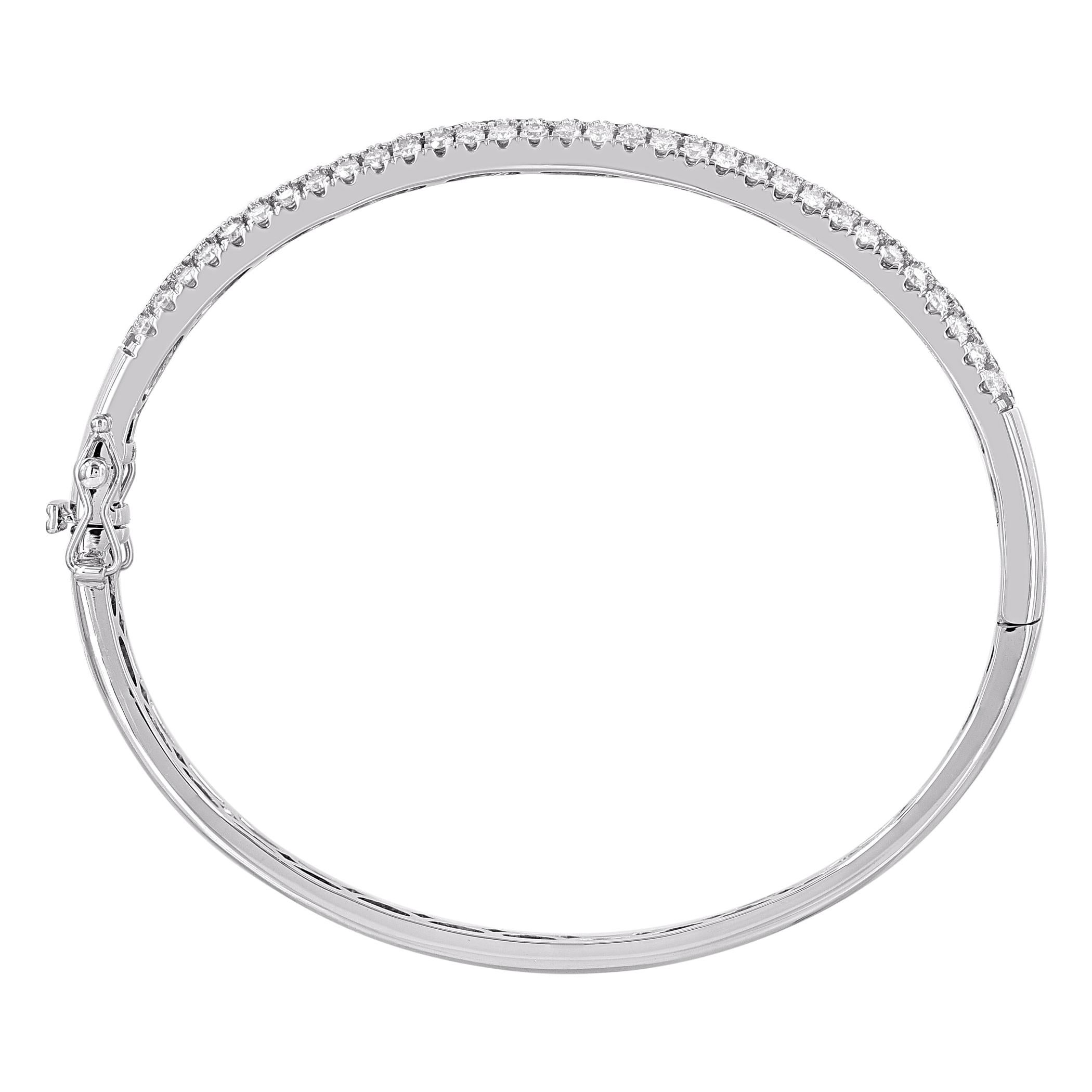 Classic and sophisticated, this diamond bangle bracelet pairs well with any attire. This shimmering bangle bracelet features 97 natural brilliant cut diamonds in prong setting and crafted in 14kt white gold. Diamonds are graded H-I color, I2 clarity.