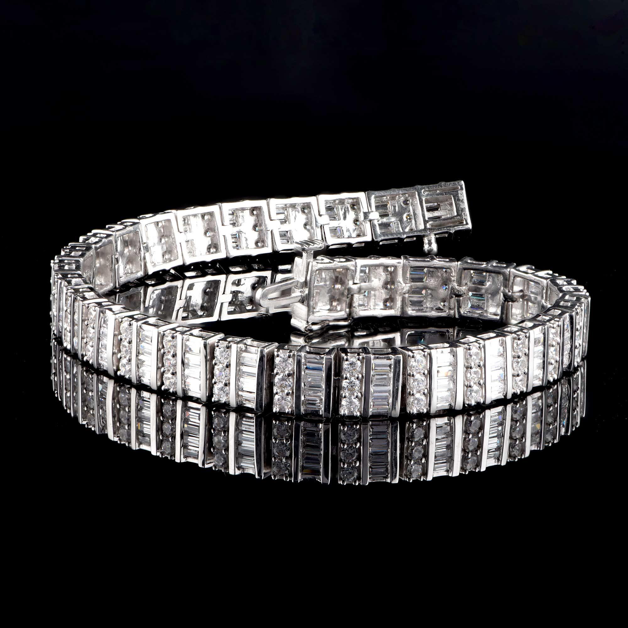 Scintillating with 90 brilliant cut and 120 baguette-cut diamonds beautifully set in prong and channel setting and crafted in 18 kt white gold. The total diamond weight is 5 carats and the diamonds are graded H-I Color, I2 Clarity.