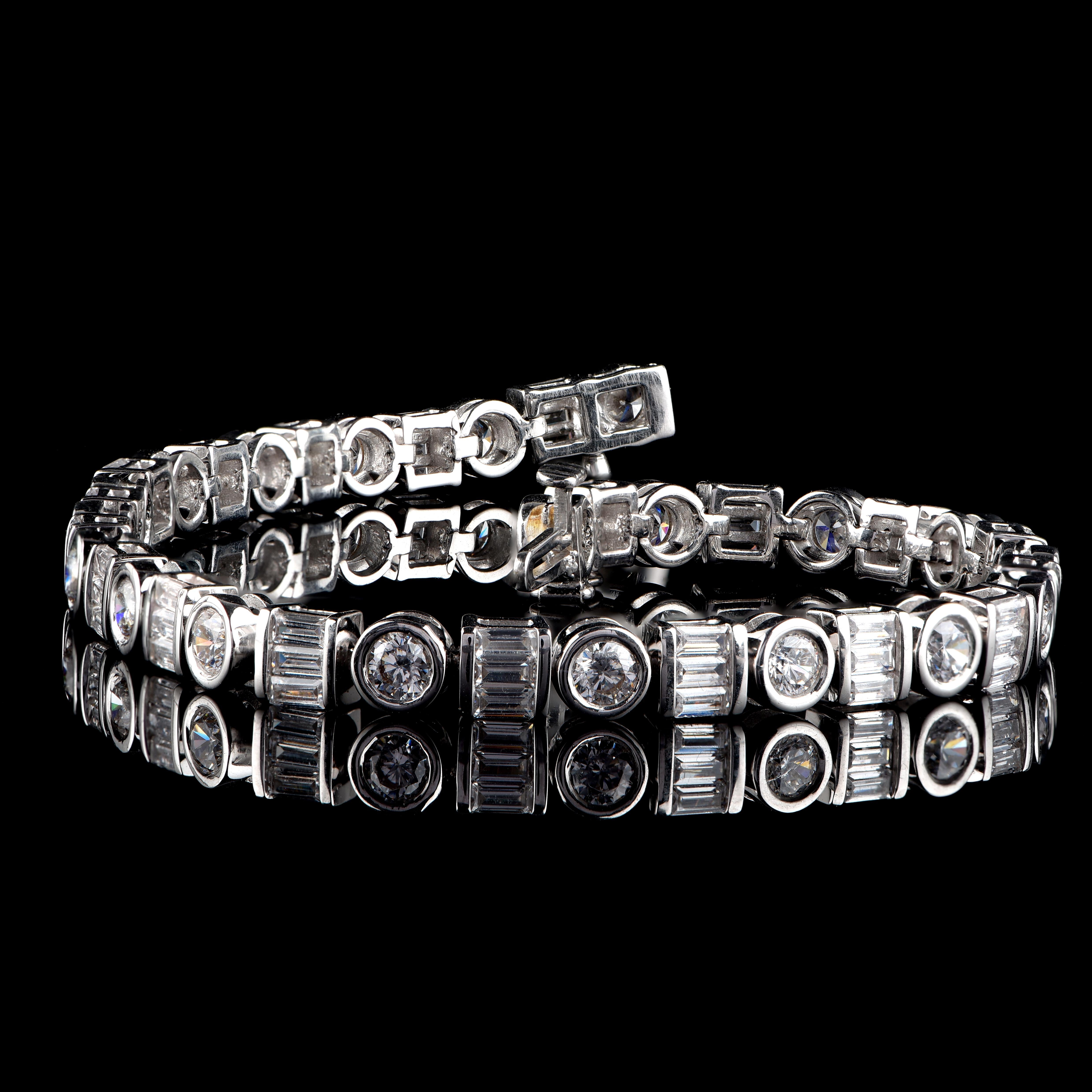 This stunning bracelet is perfect for everyday wear. It is studded with 80 brilliant cut and baguette cut diamonds in bezel & channel setting and crafted in 14 karat white gold. Diamond are graded H-I Color, I2 Clarity. Bracelet secures firmly with