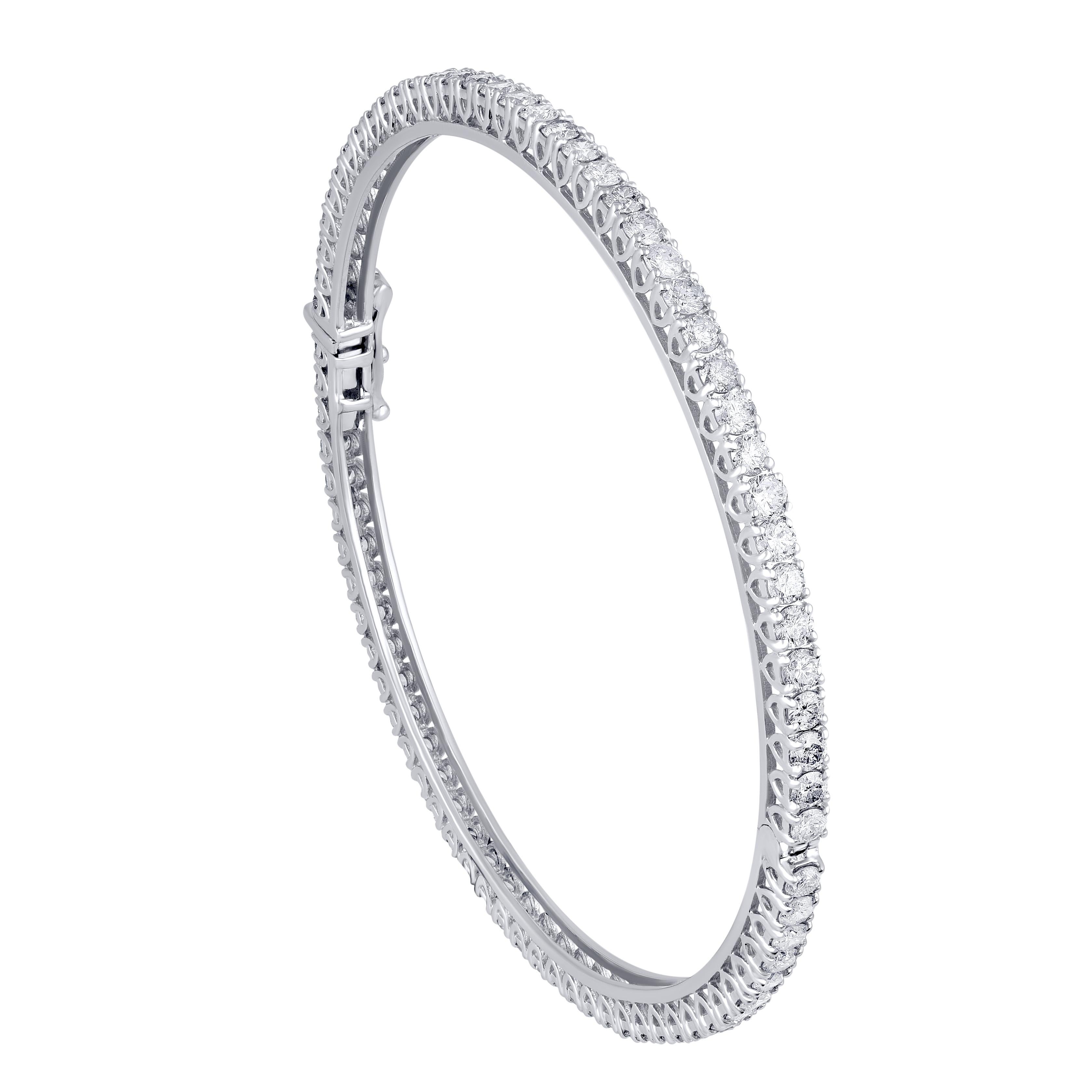 A shimmering piece of jewelry, this classic bangle is studded with 76 diamonds in prong setting and is crafted beautifully in 14 KT gold. Diamond details H-I Color, I2 Clarity. This piece comes along with inhouse authentication card. Will make a