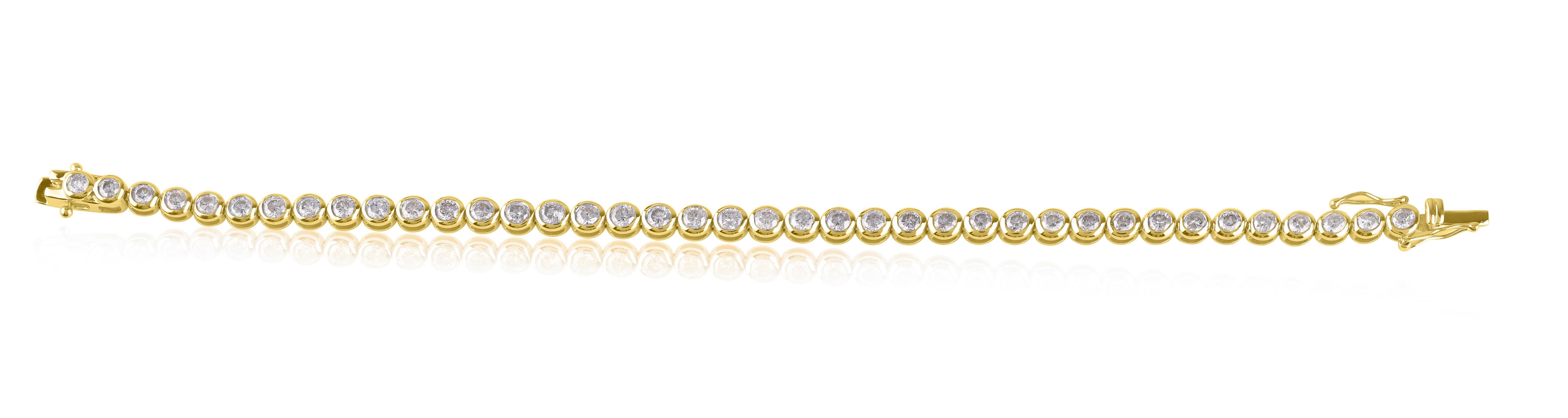 Illuminate your wrist with this dazzling diamond tennis bracelet. 39 round-cut diamonds studded elegantly in bezel setting. The diamonds are graded HI Color, I2-I3 Clarity. Handcrafted in 14 KT yellow gold, the bracelet comes along with an