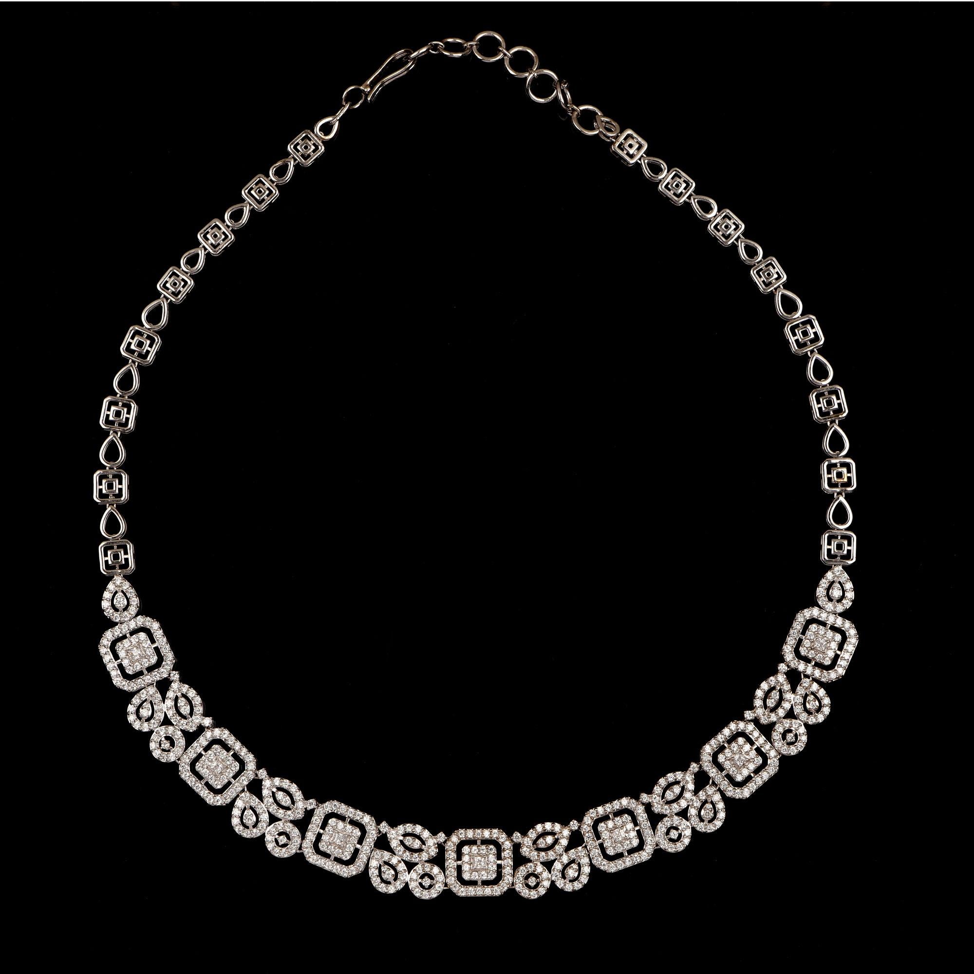 Exquisite and elegant, perfect for holiday gifting. This designer necklace features 518 brilliant cut and 7 princess-cut diamonds elegantly set in prong setting and is hand-crafted in 18 Karat white gold. The diamonds are graded H-I Color, I2