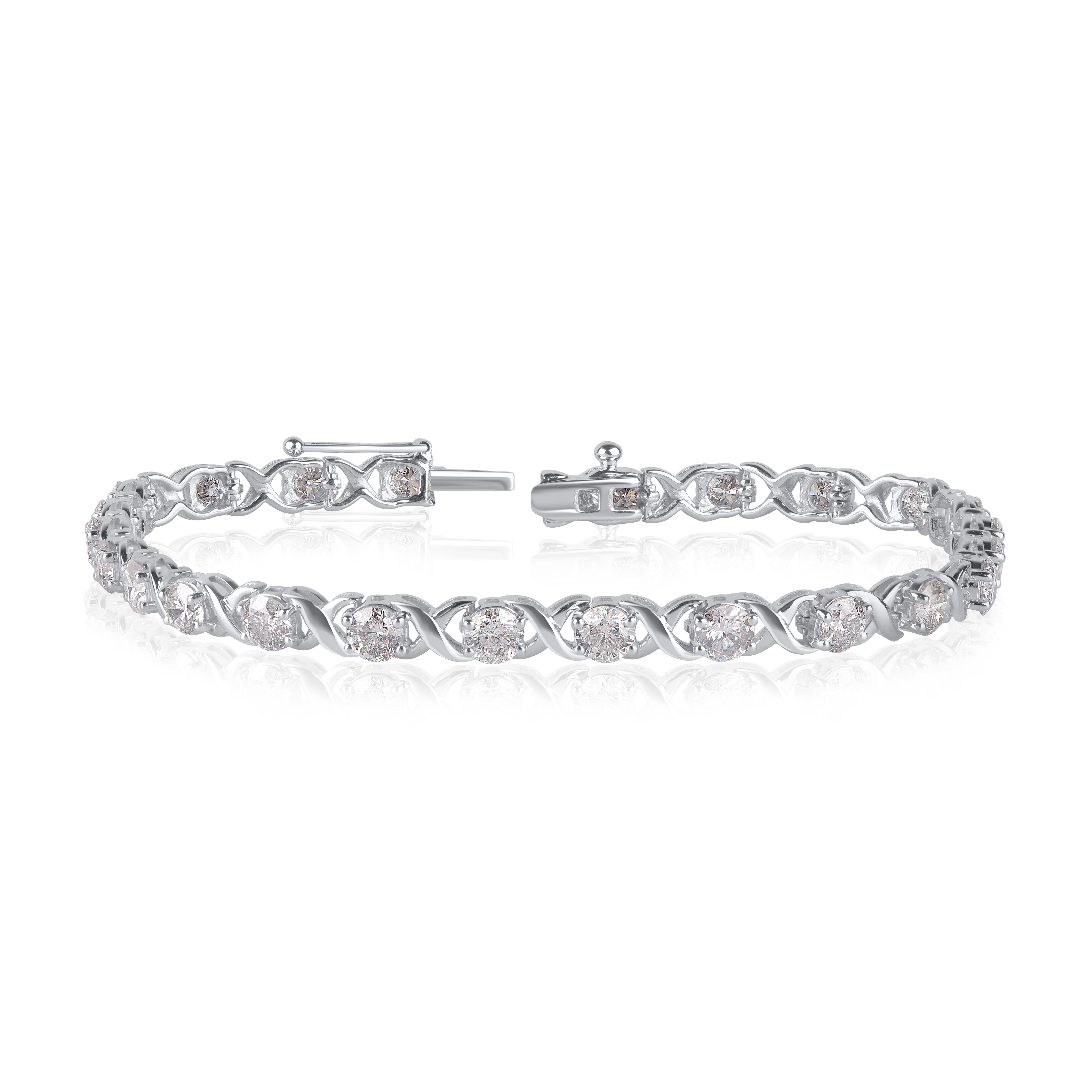 This diamond tennis bracelet has a smart and stylish look. It is crafted in 10 kt white gold and shines brightly with 24 round-cut diamonds embedded elegantly in prong setting. The diamonds are graded H-I Color, I1-I2 Clarity and this diamond tennis