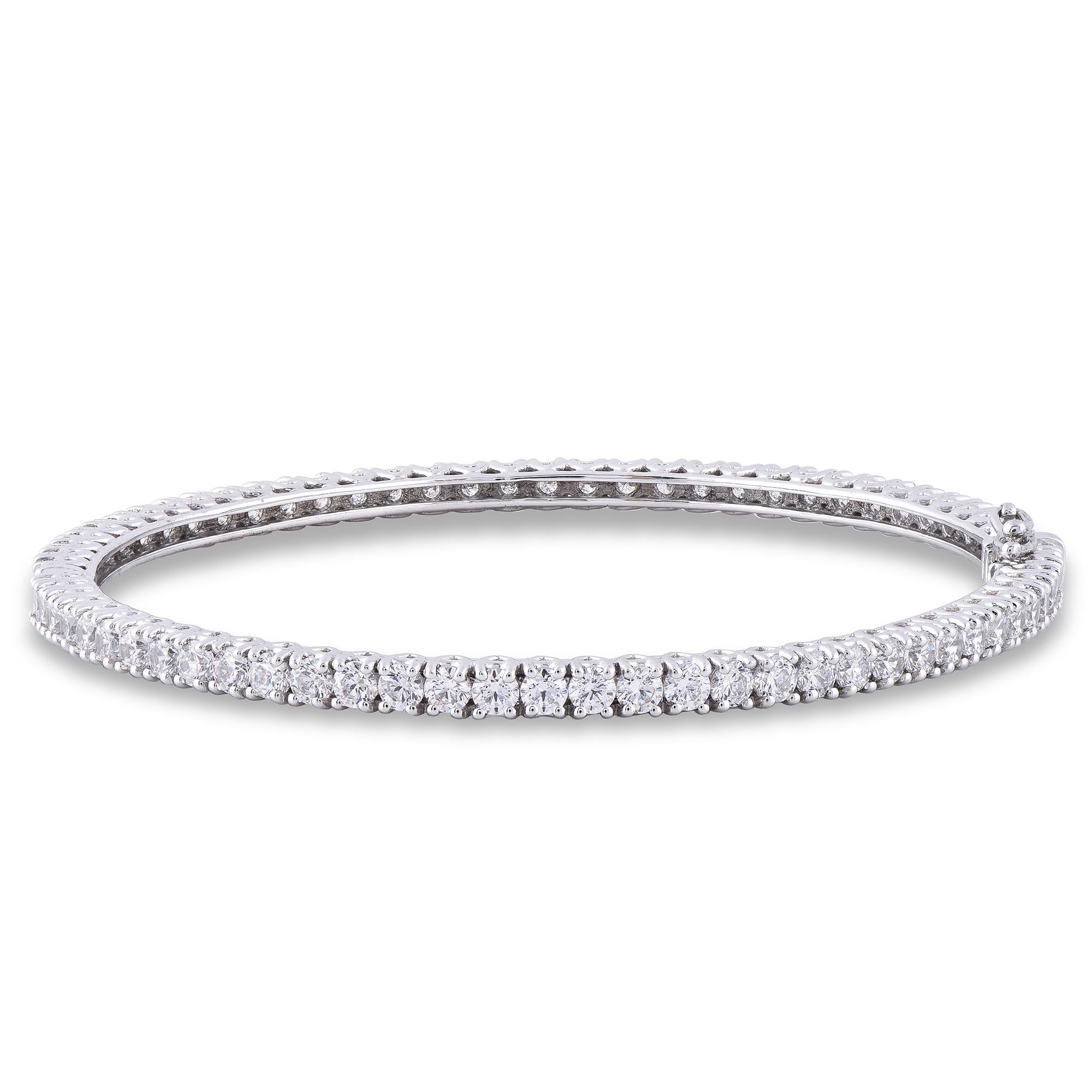 A graceful addition to her wardrobe, this diamond tennis bangle brings the perfect touch of sparkle to her look. Beautifully hand-crafted by our inhouse experts in 18 karat white gold and embedded with 70 round brilliant diamond in prong setting.