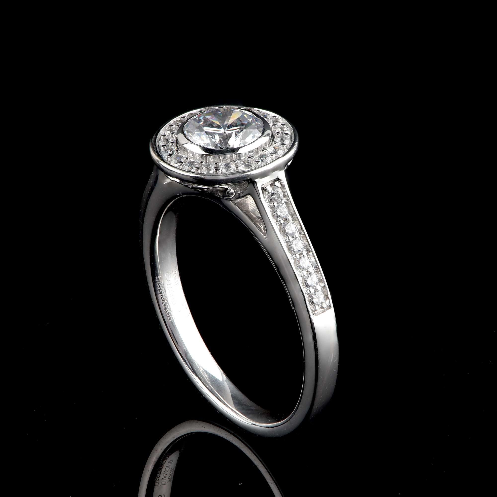 This bridal ring shines beautifully with 33 brilliant-cut diamonds and 1 GIA certified centre stone set in pave and bezel setting - crafted in 18-karat white gold. The diamonds are graded H Color, SI1 Clarity. 

Metal color and ring size can be
