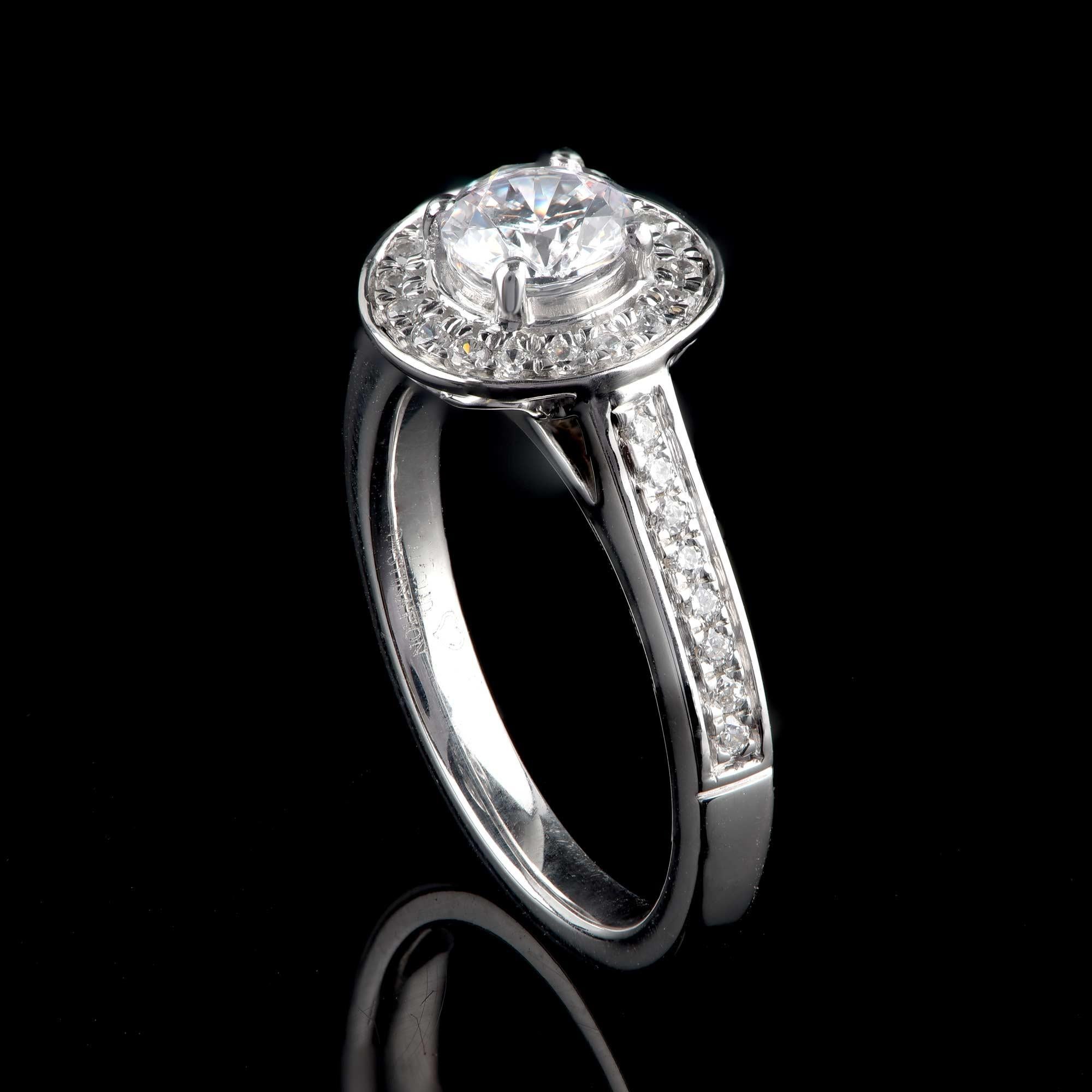 Expertly hand-crafted by our skillful craftsmen in 18-karat white gold and studded with 35 brilliant-cut diamonds and 1 GIA certified center stone in prong and micro-pave setting. The diamonds are graded H Color, SI1 Clarity. 

Metal color and ring