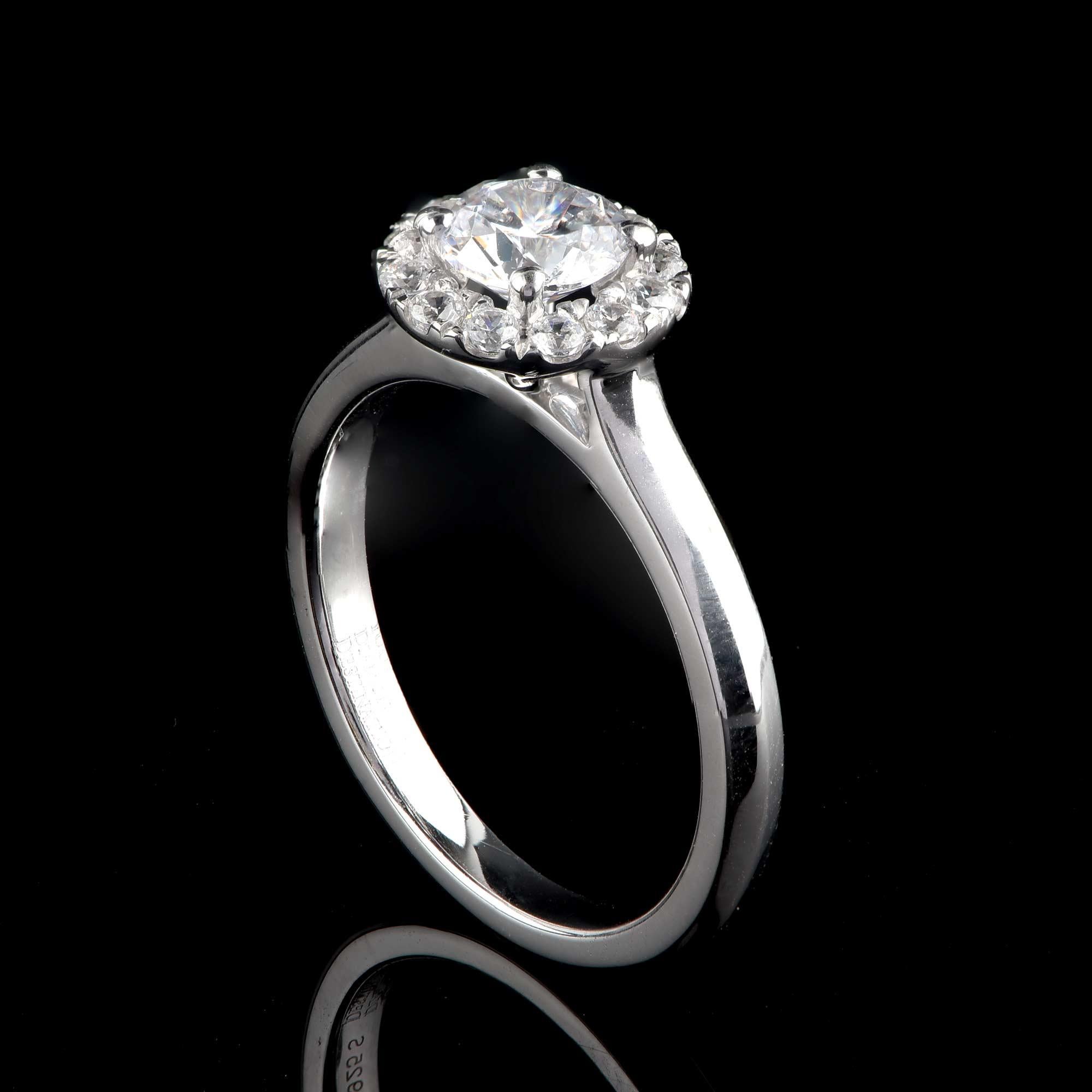 This bridal ring is intricately crafted by our in-house experts in 18-karat white gold and is studded with 12 brilliant-cut diamonds and 1 GIA Certified 0.70ct center stone in prong setting. The diamonds are graded H Color, SI1 Clarity. 

Metal