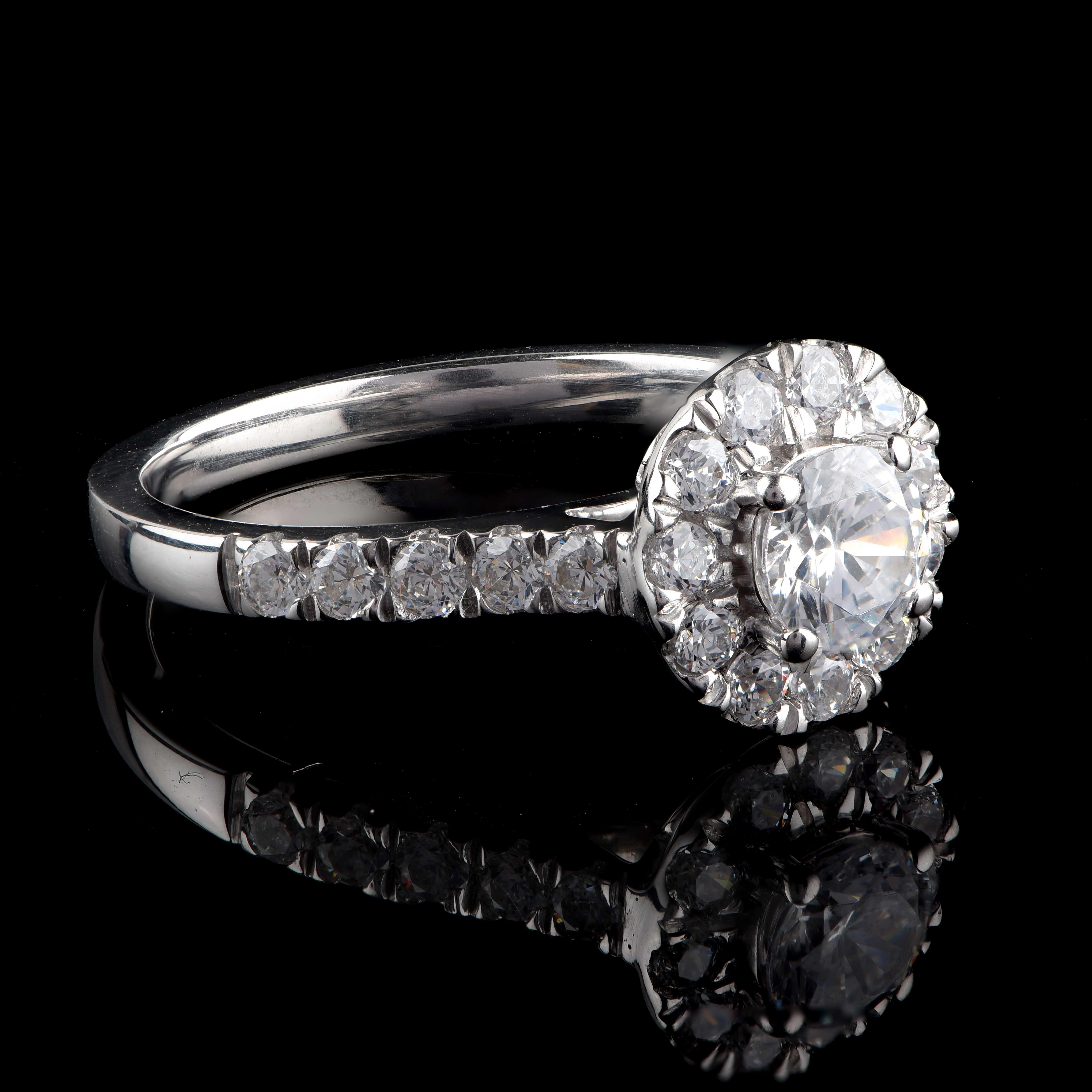 Cette bague de mariage est ornée d'une pierre centrale certifiée par le GIA et de 21 diamants taille brillant en sertissage à griffes. Elle est fabriquée en or blanc 18 carats. Les diamants sont classés Couleur H, Clarté SI1.