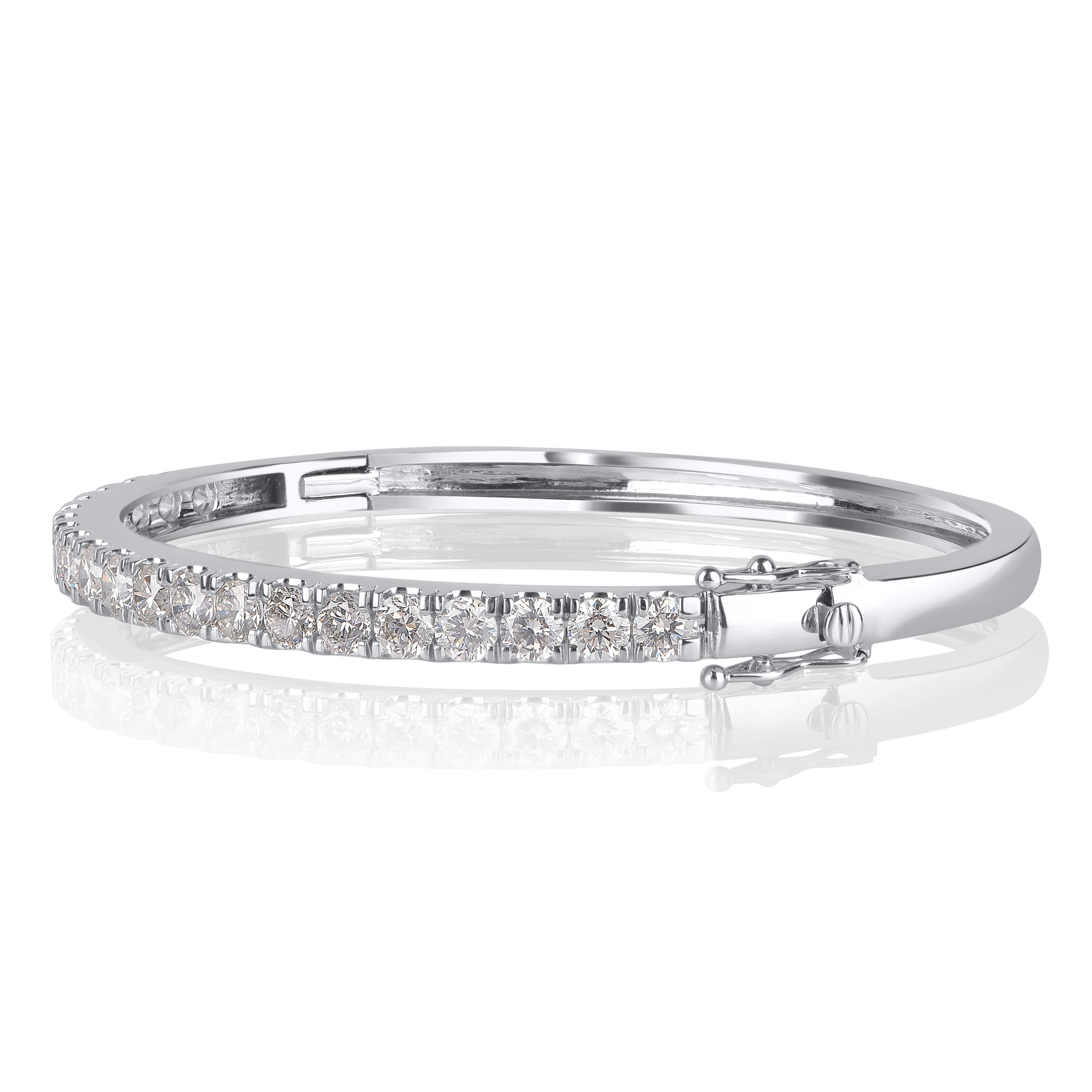 Hand-crafted by our in-house experts in 14 kt white gold, sparkling with 21 round-cut diamonds beautifully set in micro-prong setting. Diamonds in this bangle are graded HI Color, I1-I2 Clarity. This bangle is secured comfortably with pusher safety