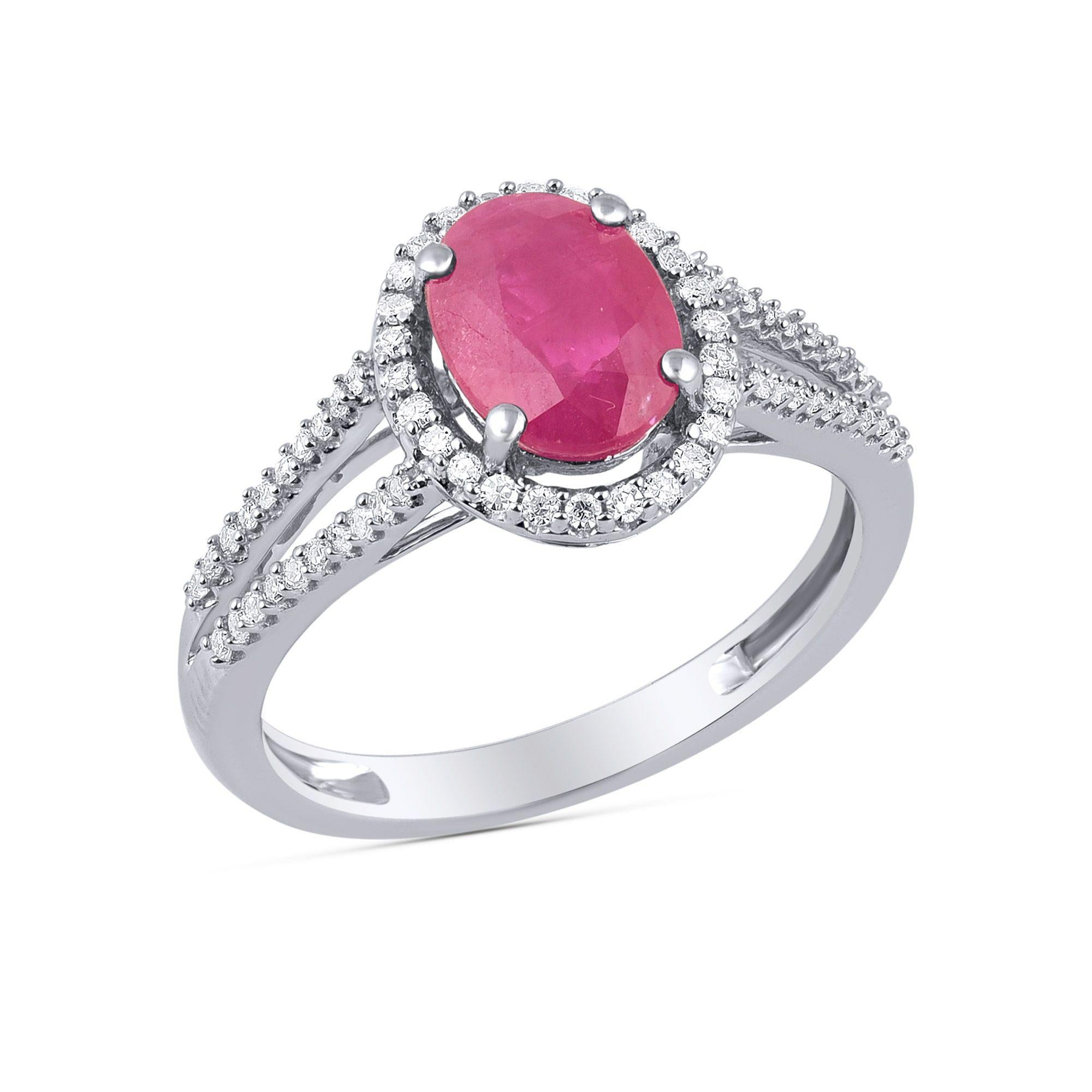 This 0.20 carat split shank diamond and ruby engagement ring is made in 18 karat white gold and studded with 66 round-cut diamonds and 1 oval shaped ruby gemstone in prong and pressure setting. Diamonds are graded H-I Color, I1-I2 Clarity
