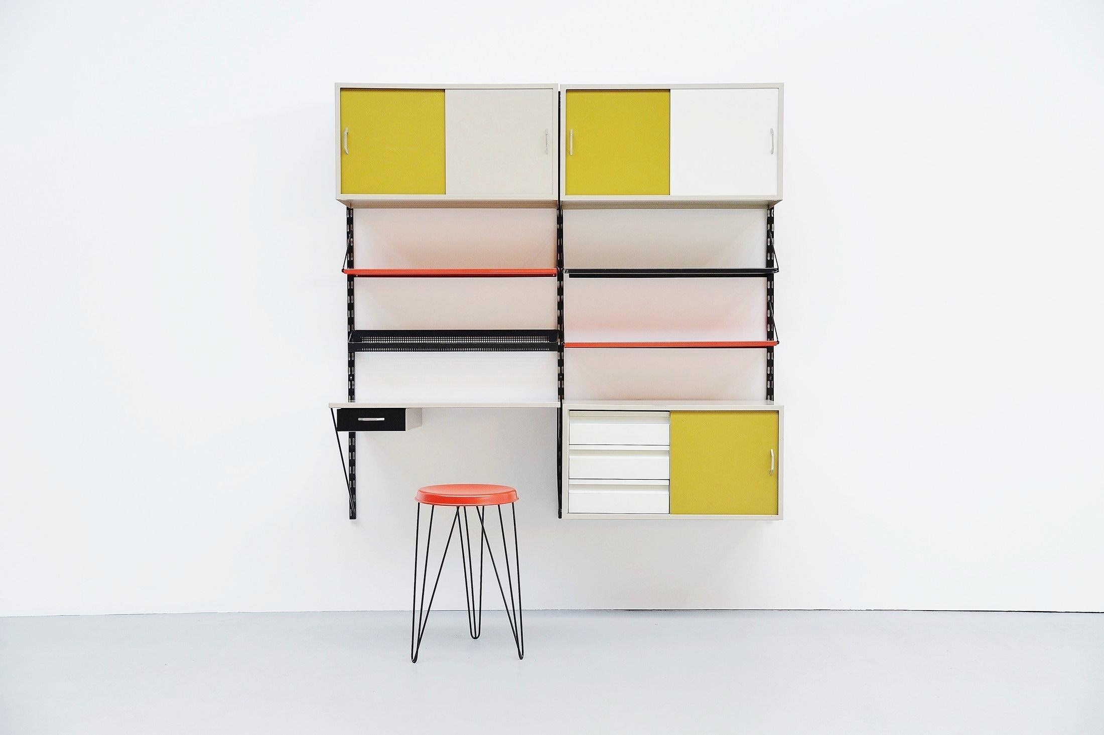 Very cool and complete shelving system / bookcase, designed by Tjerk Rijenga and manufactured by Pilastro, Holland, 1960. This is a very nice medium sized and very complete wall unit with some nice options included. This unit contains some shelves,