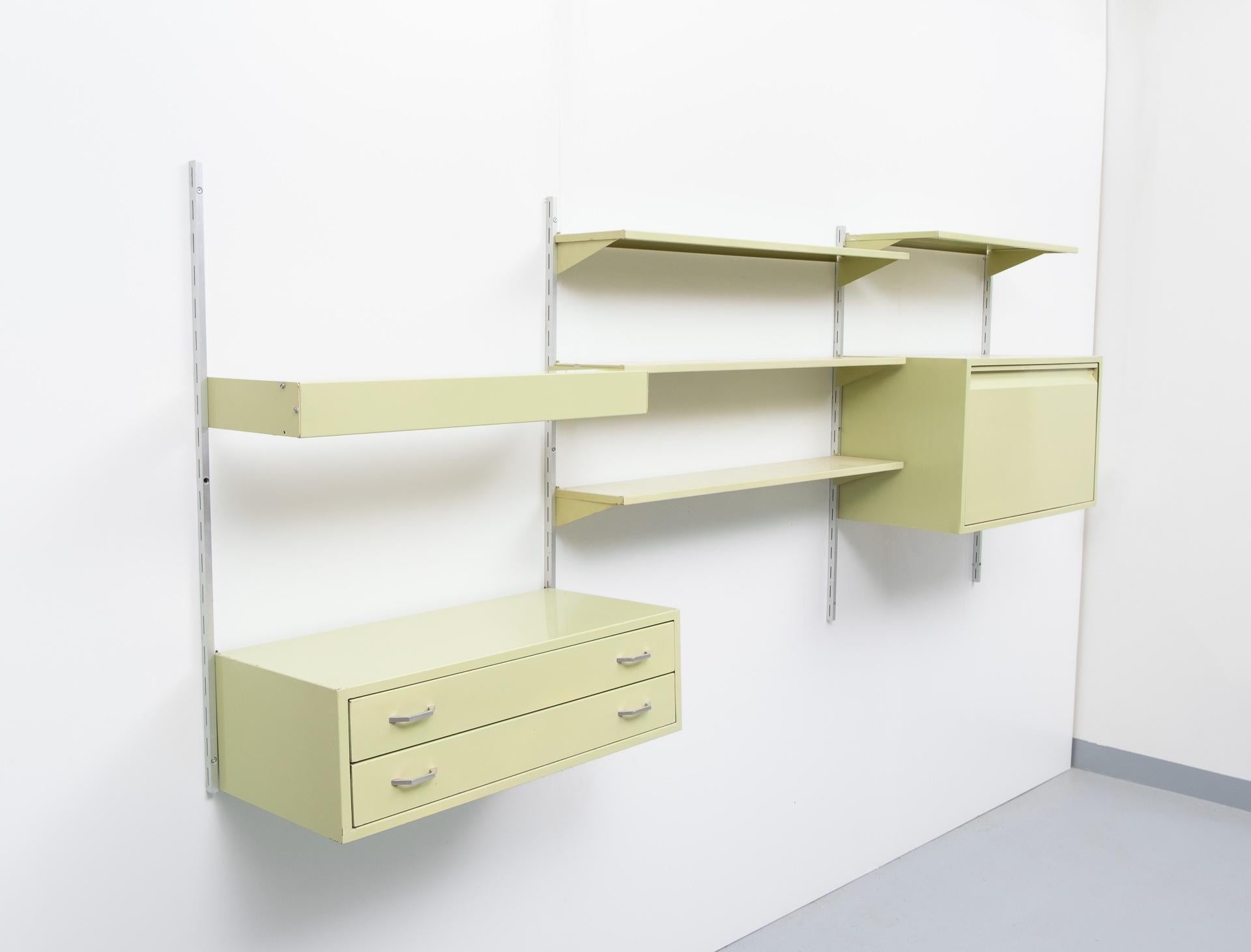 Tjerk Reijenga serie Combinare manufactured Pilastro, Holland, 1950s. Very rare set.
7 aluminum rails, two cabinets, one-light bare, and four shelves. In a typical 1950s green color.
   