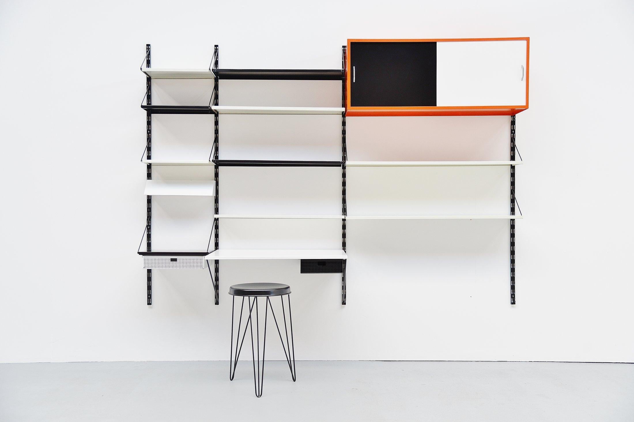 Very cool and complete shelving system / bookcase, designed by Tjerk Rijenga and manufactured by Pilastro, Holland, 1960. This is a very nice large sized and very complete wall unit with some nice options included. This unit contains some shelves, a