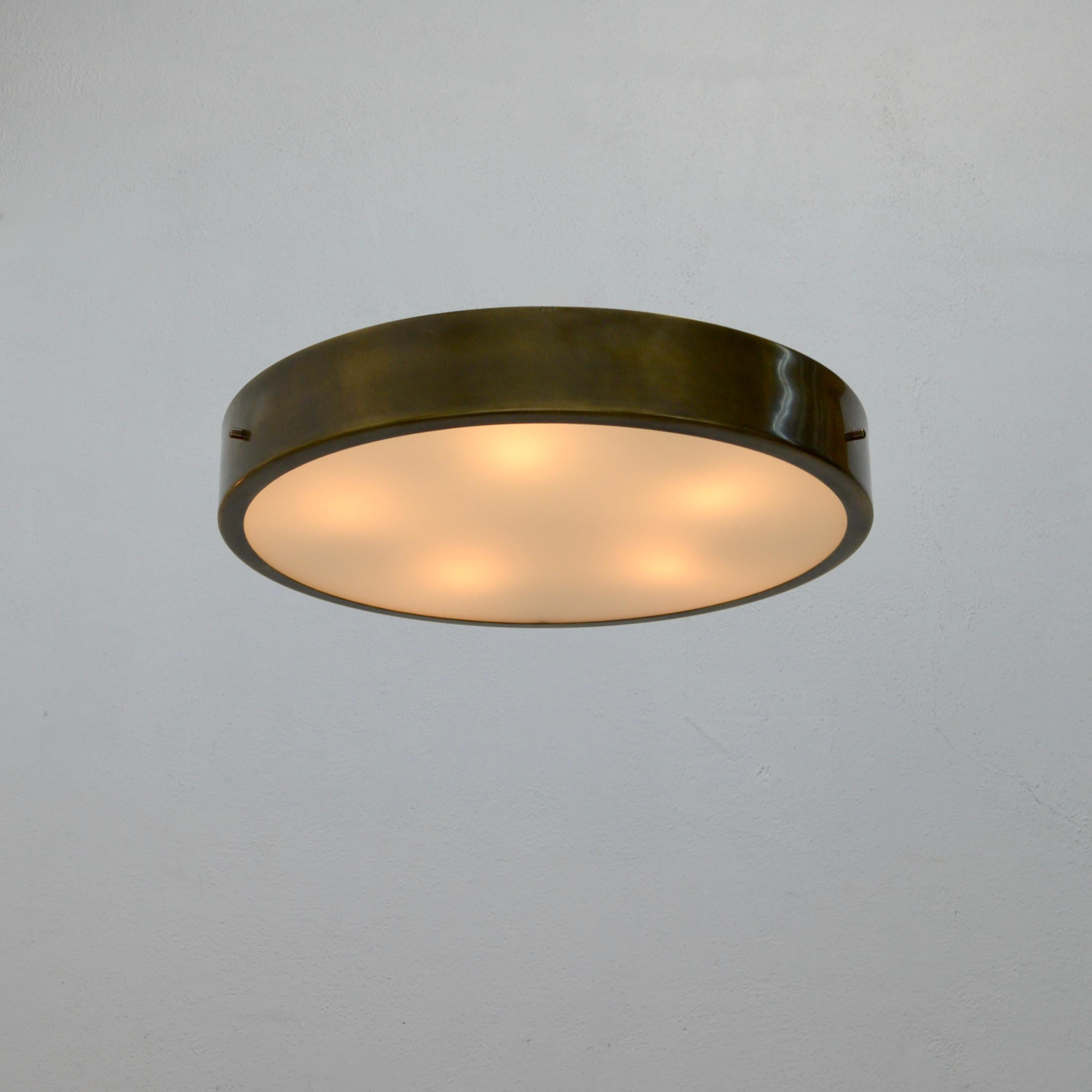 TLUnnel is a simple effective circular flush mount design. Modern in nature yet Classic vintage light source set up. Made in brass, aluminum and glass. Also available in satin aged nickel finish. Wired with 5-E26 medium based sockets (24