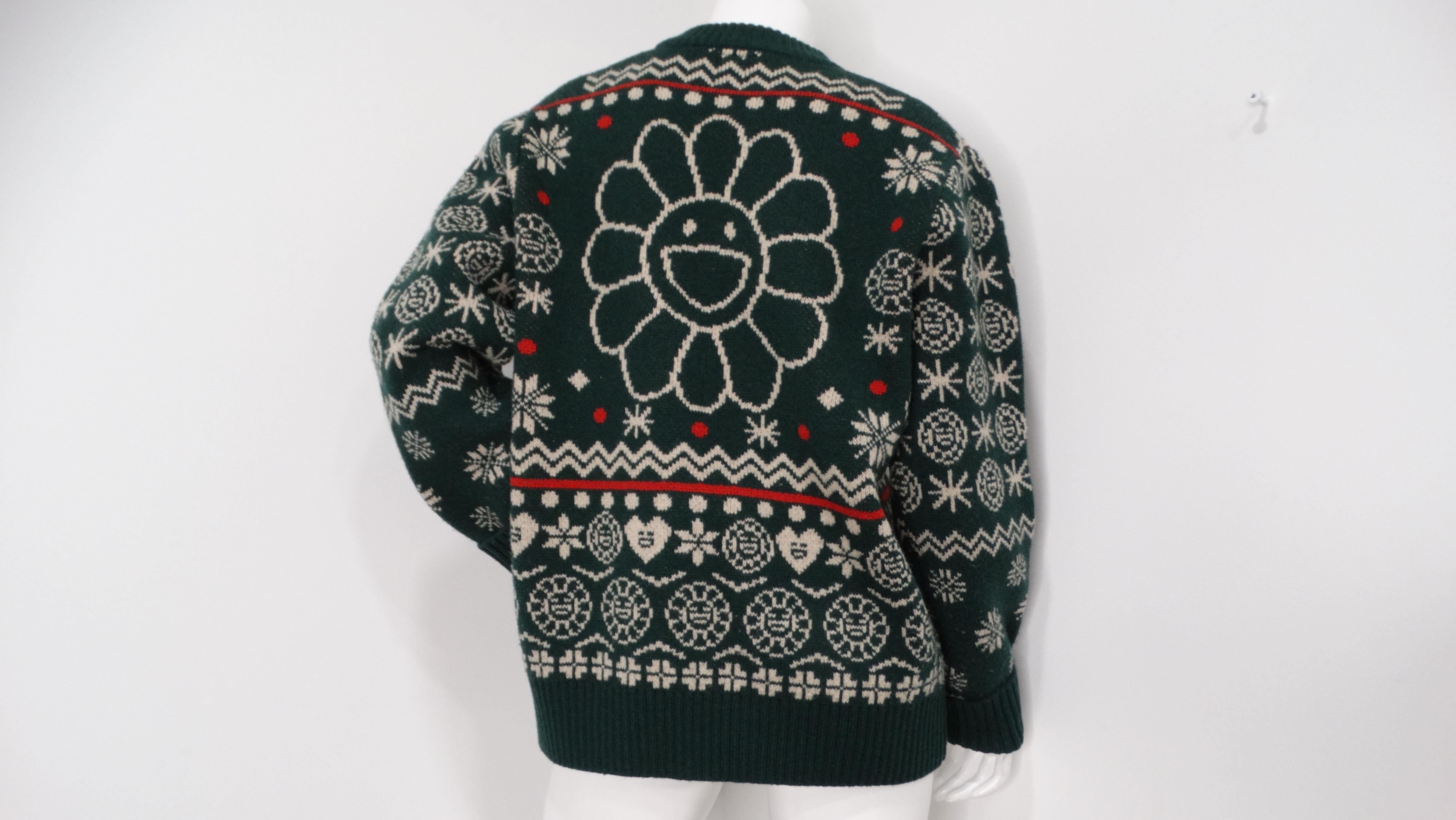 The TM/KK Takashi Murakami Wool Holiday Print Sweater is a vibrant and eye-catching piece that exemplifies the artistic fusion of high fashion and pop art. Crafted from premium wool, this sweater features Takashi Murakami's signature playful prints,