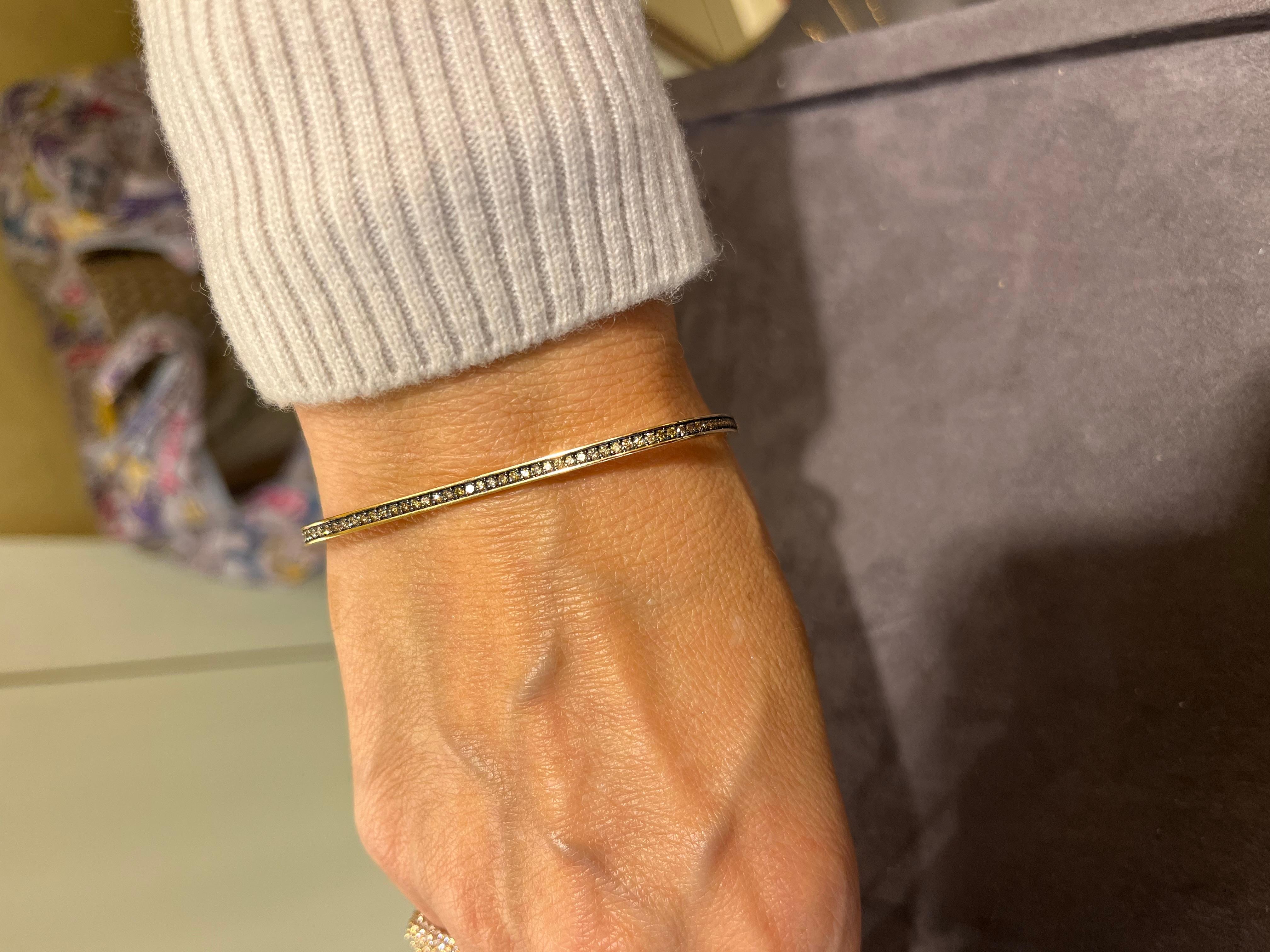 Times Square Bangle Bracelet is a unique 14 K Gold 9 gr bracelet 
there are 0,65 carats Champaigne diamonds