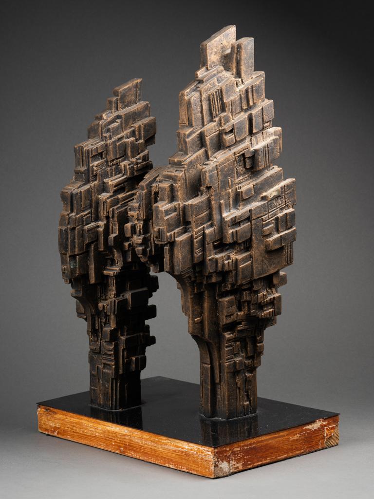 T. Mire (XXth c.) : Futuristic architecture

Original sculpture made of patinated plaster , wood and black formica base showing a futuristic architecture probably made in the 60's
 
Signed : 
