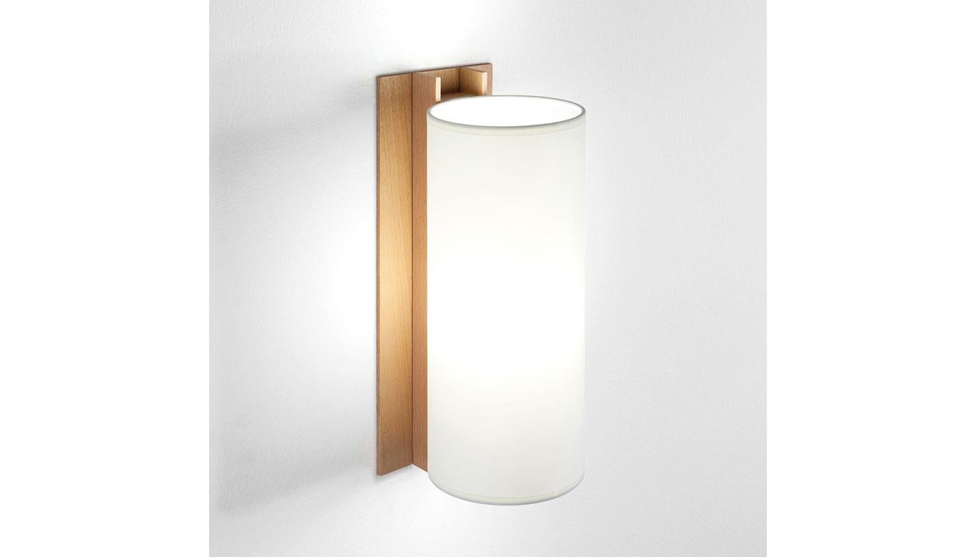 TMM Largo Wall Light by Miguel Mila for Santa & Cole. Originally designed in Spain in 1964. The TMM collection of short and long wall lamps comprises a simple beech channel into which the white or beige parchment shade is partially inserted. The