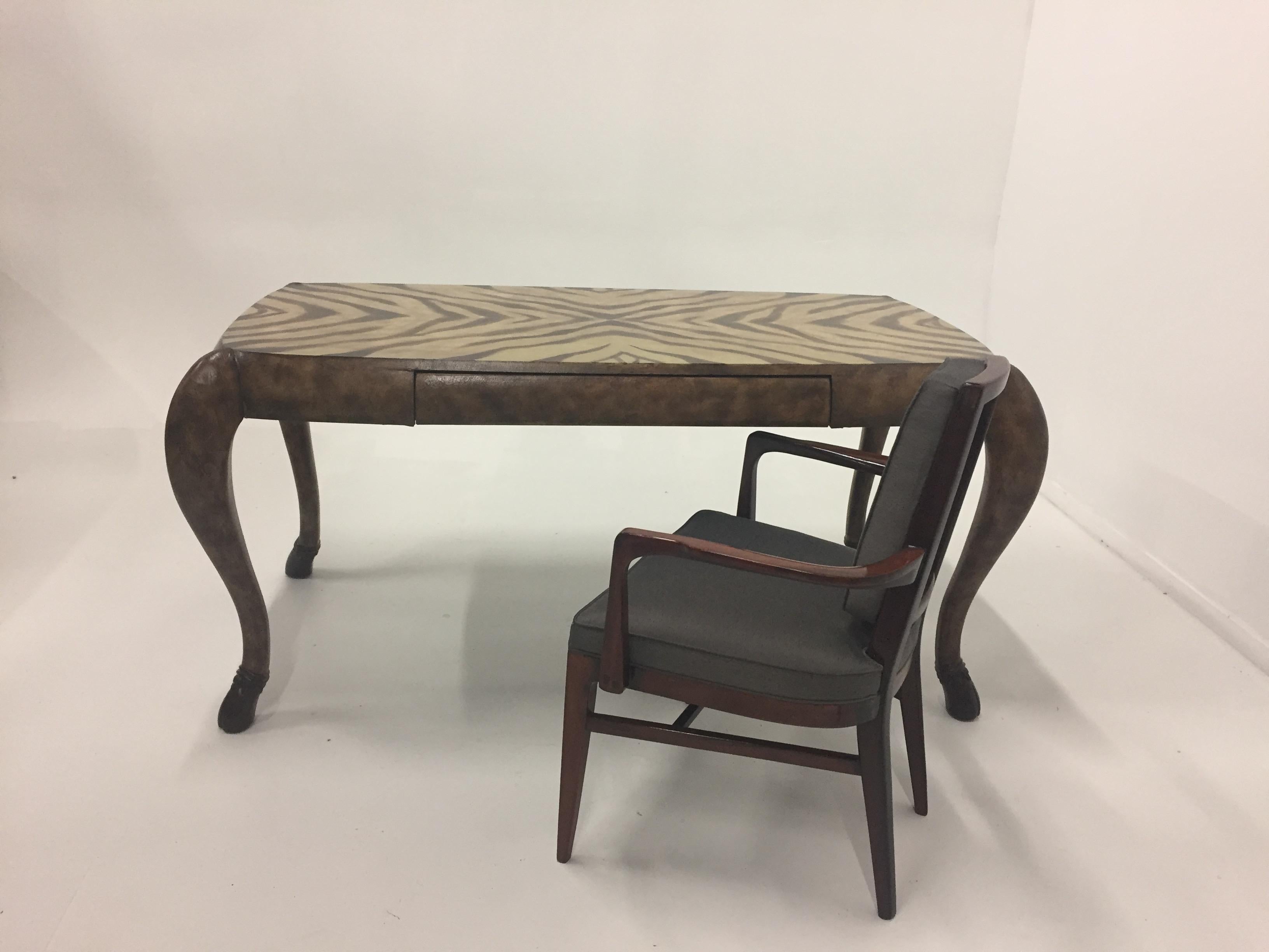 Unbelievably chic writing desk that's wrapped in rich brown leather and has a zebra motif pattern on the top. Beautifully crafted by Maitland Smith, the desk has a single drawer and handsome hoof shaped feet that are ebonized wood at very