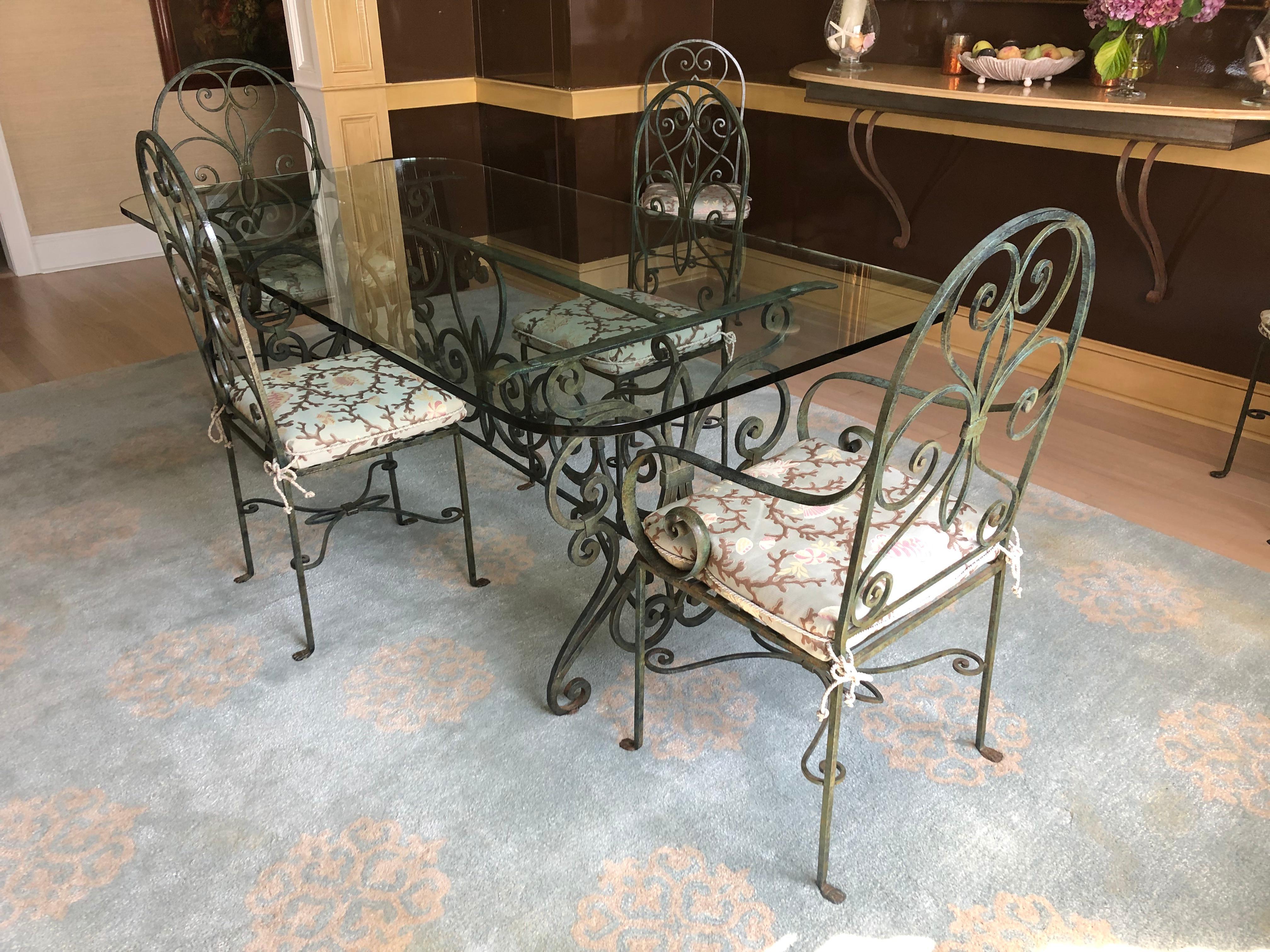 Super dramatic one of a kind dining table and 8 chairs having curlicue verdigris wrought iron and more than 6.5 feet long glass top .75 thick.
Base itself without glass 57 L 32 D 30 H
Armchairs 19.75 w 19 d 42 h arm height 26.75 seat height with