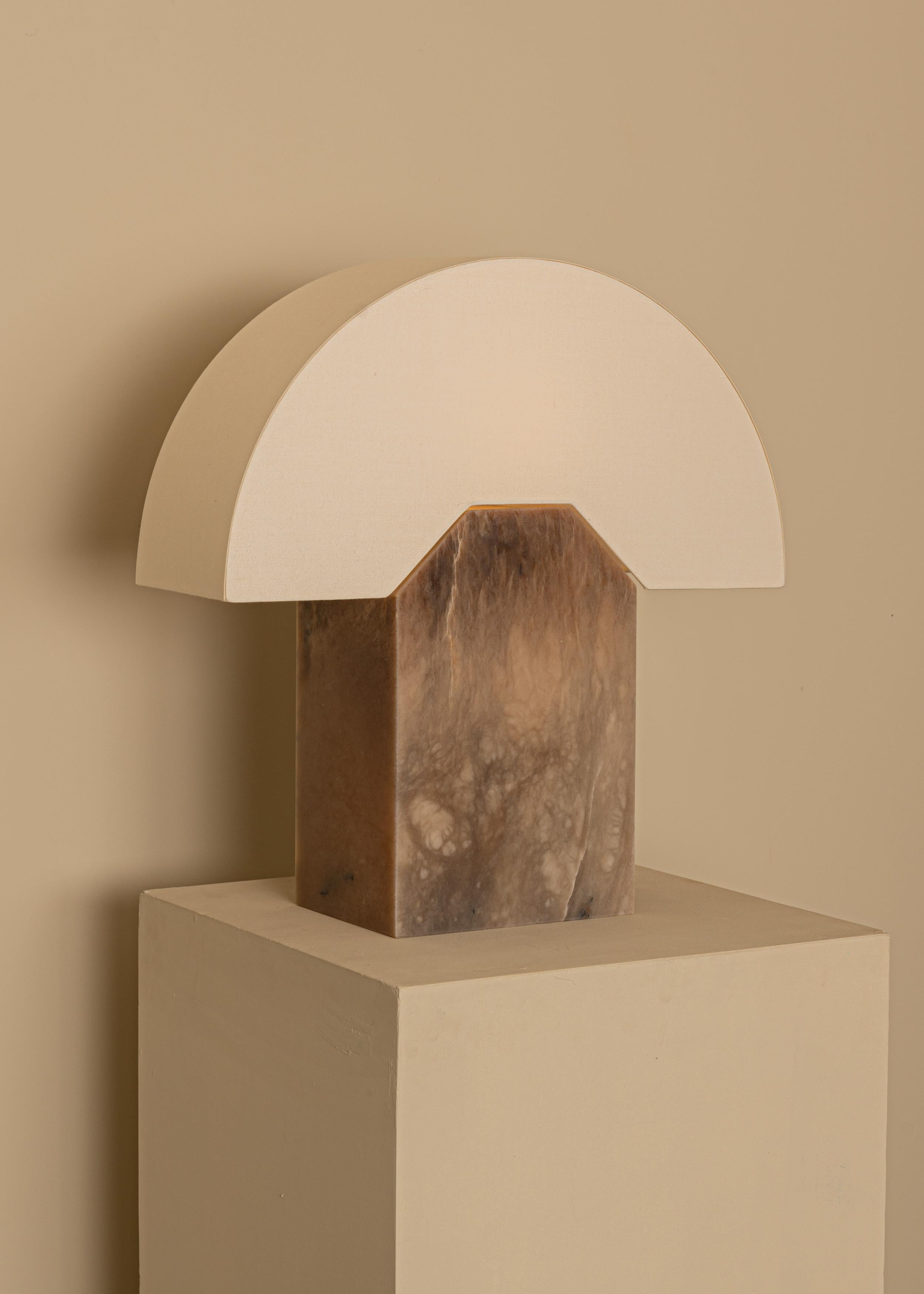 TobaccoAlabaster Edna Table Lamp by Simone & MarcelMarcel
Dimensions: D 15 x W 44 x H 46 cm.
Materials: Cotton, brass and white alabaster.

Also available in different marbles and ceramics. Custom options available on request. Please contact us.