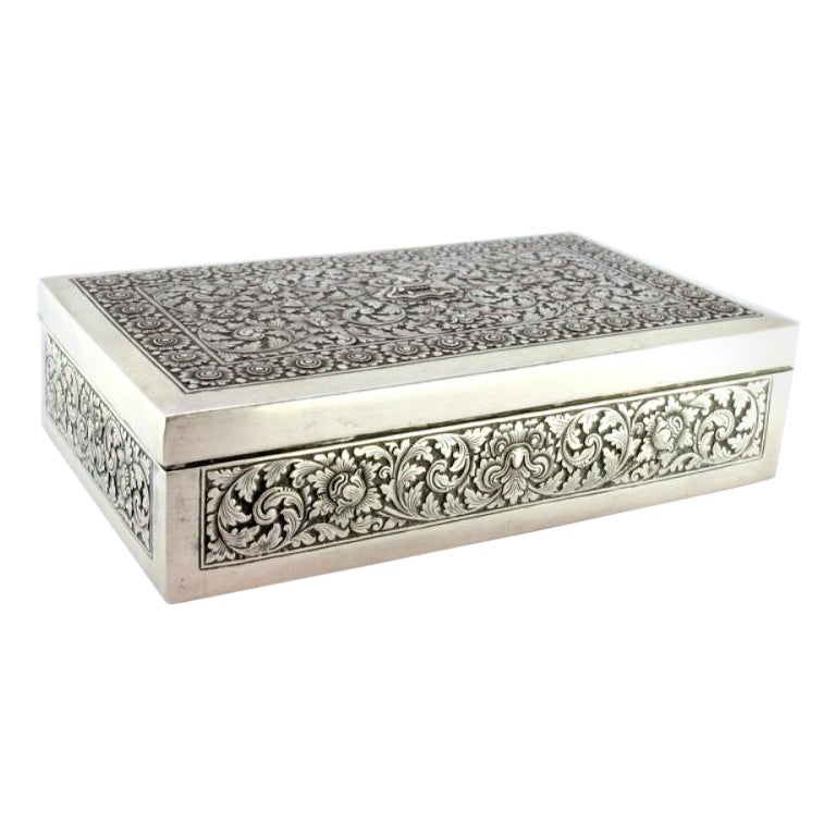 Tobacco box in embossed silver with Asian motifs and wood-lined interior