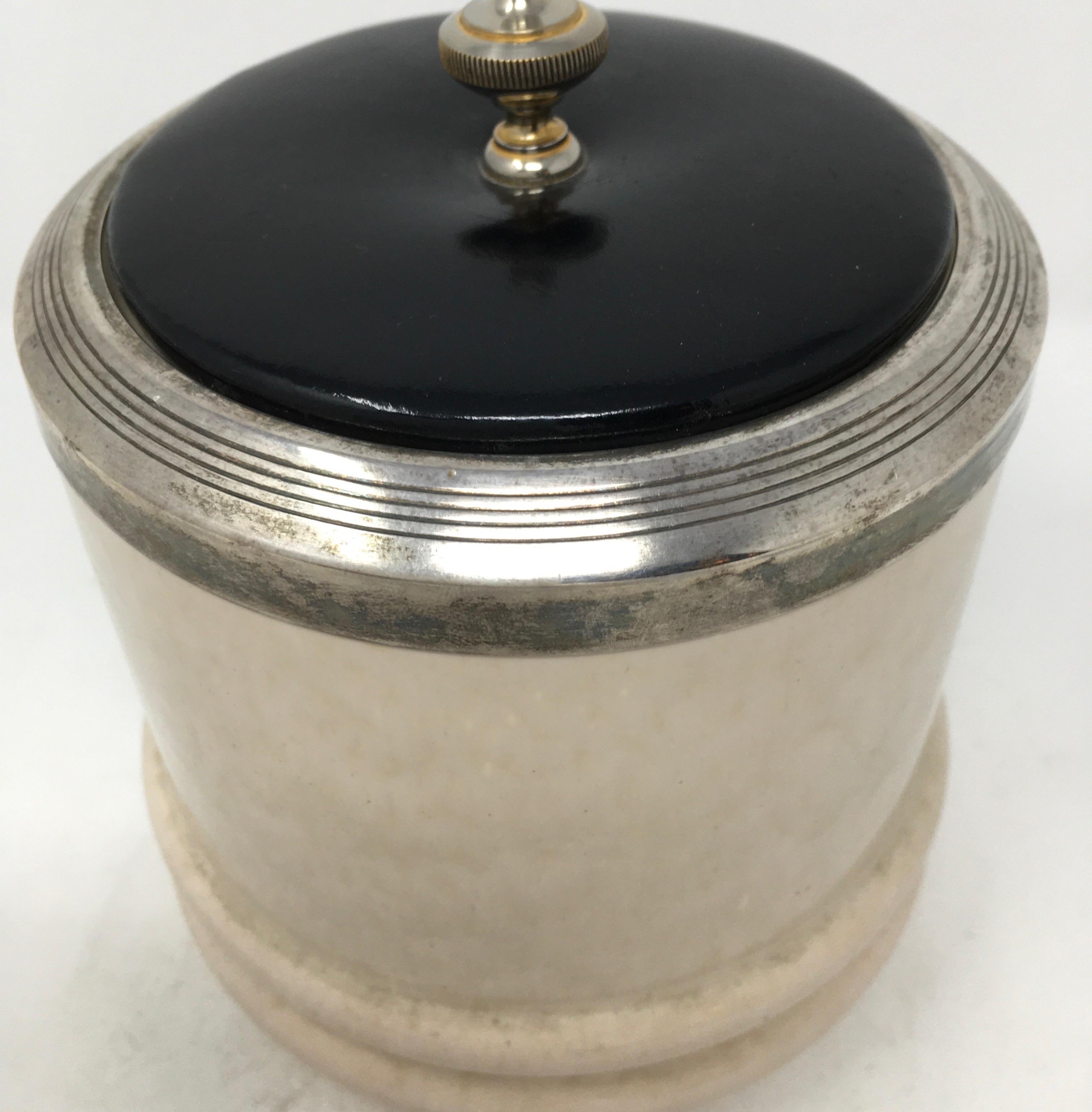 This handsome ceramic tobacco canister has a silver plated rim band and finial. The lid is of wood and has a cork liner.