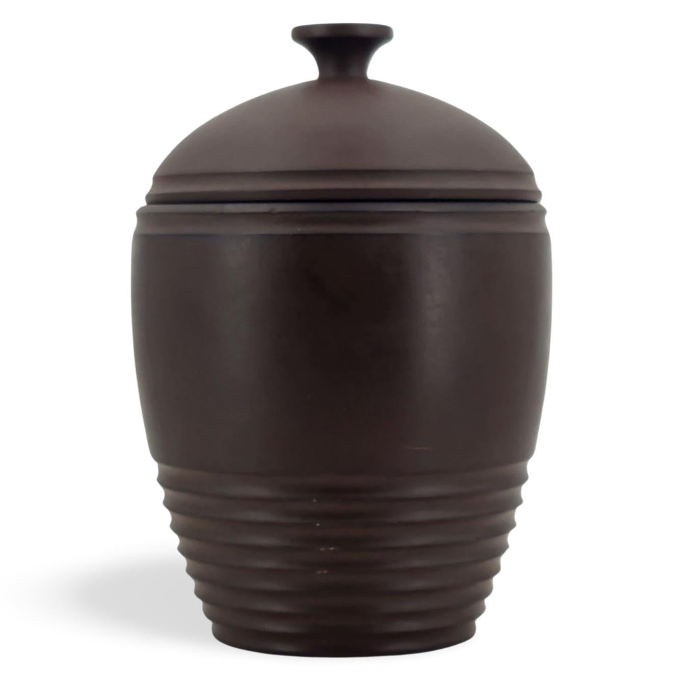 One of Murray's particularly successful designs, the Tobacco Jar stands as a testament to the singular beauty of line and form, with no need for additional decoration. This example is in Bronze Basalt, an unsual form of pottery, which was made by