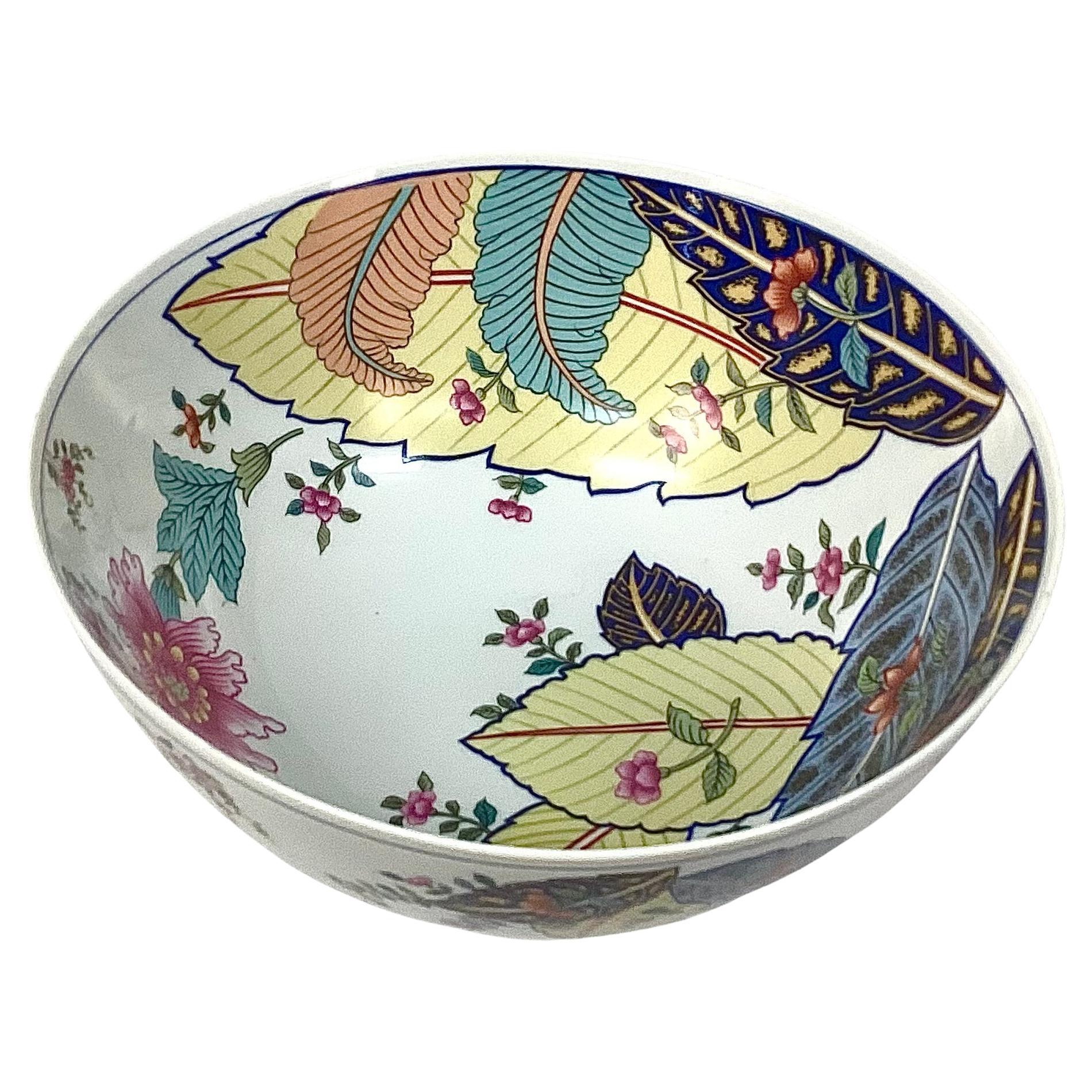 Vintage Seymour Mann Tobacco Leaf 10 inch porcelain bowl. Bowl features large leaves, flowers and foliage in bright colors of blue, green, yellow and pink on a white background. Maker's mark on bottom. No chips or cracks. Nice large serving bowl.