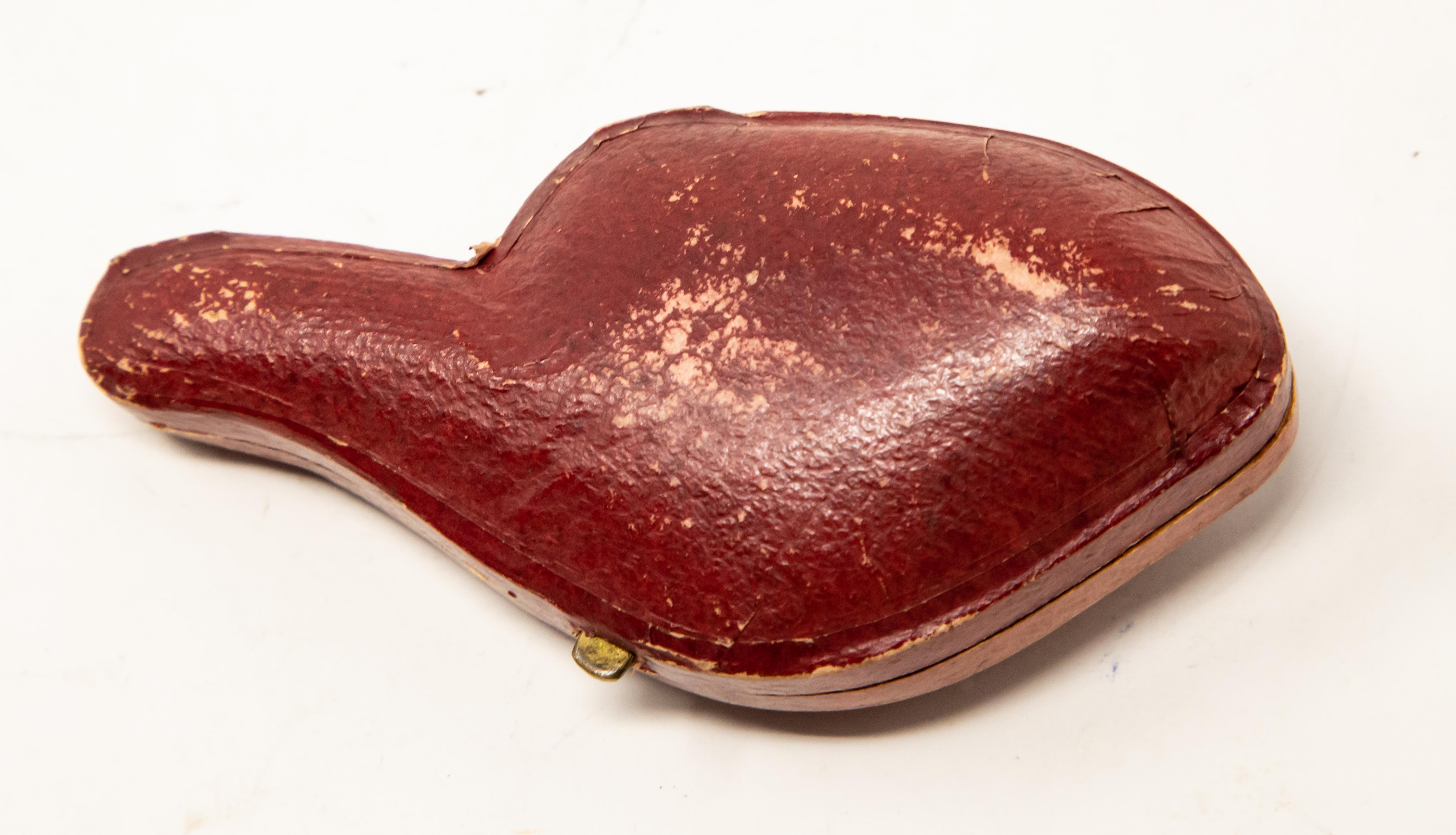 Offering this magnificent hand carved tobacco pipe. The case is a hard shell wrapped in a red leather. The pipe has an amber colored mouthpiece and a gorgeous body. The main body has a Horse that has been hand carved.