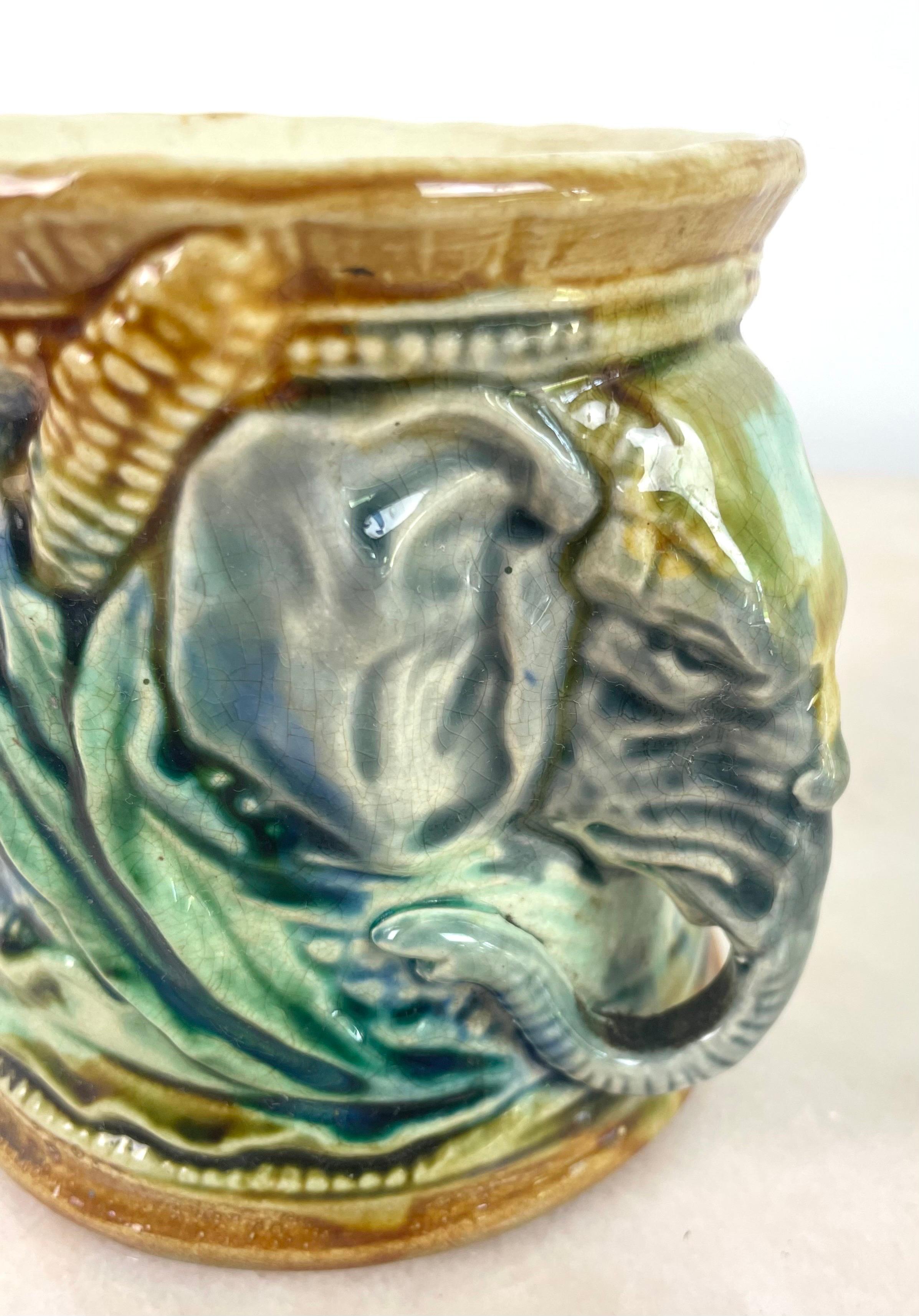 Tobacco jar or blue and green pencil jar in slip signed Frie Onnaing, circa 1890. The two handles are elephant heads, decorated with corn. The slip gives the pot a nice shiny effect. Brilliant colors.
Style: Majolica Pottery

Materials and