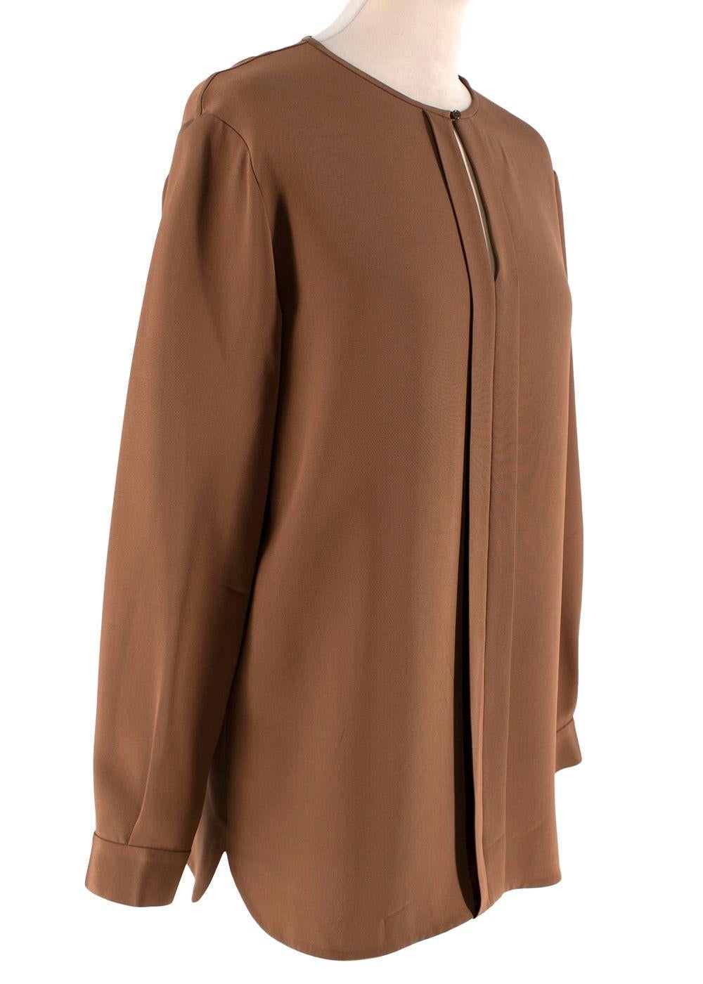 Loro Piana Tobacco Silk Keyhole Blouse

- Fluid silk blouse in a rich tobacco hue
- Collarless, with keyhole notch
- Long, button finished cuffs
- Box pleat front
- Relaxed cut

Materials 
100% Silk 

Made in Italy 
Wash separately inside out 

Item