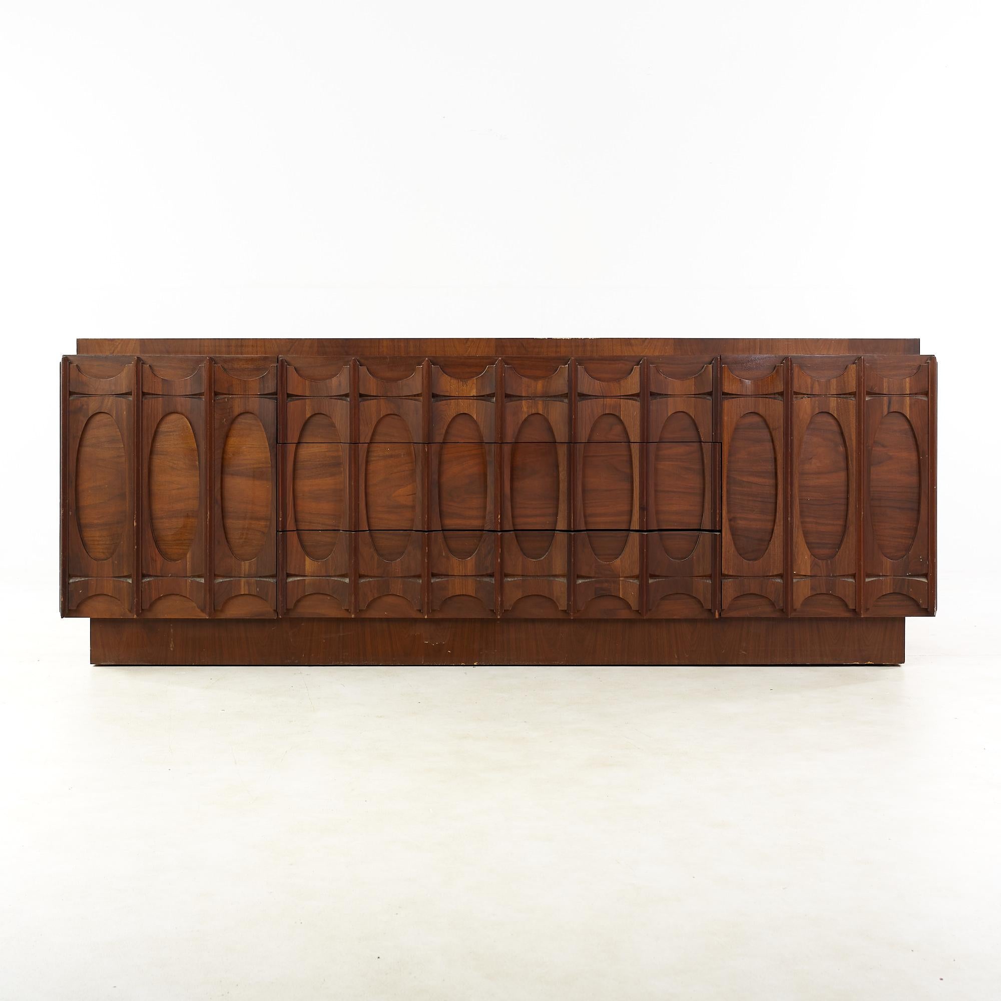 Tobago Brutalist mid-century walnut 9 drawer lowboy dresser.

This dresser measures: 81 wide x 22 deep x 30 inches high.

All pieces of furniture can be had in what we call restored vintage condition. That means the piece is restored upon