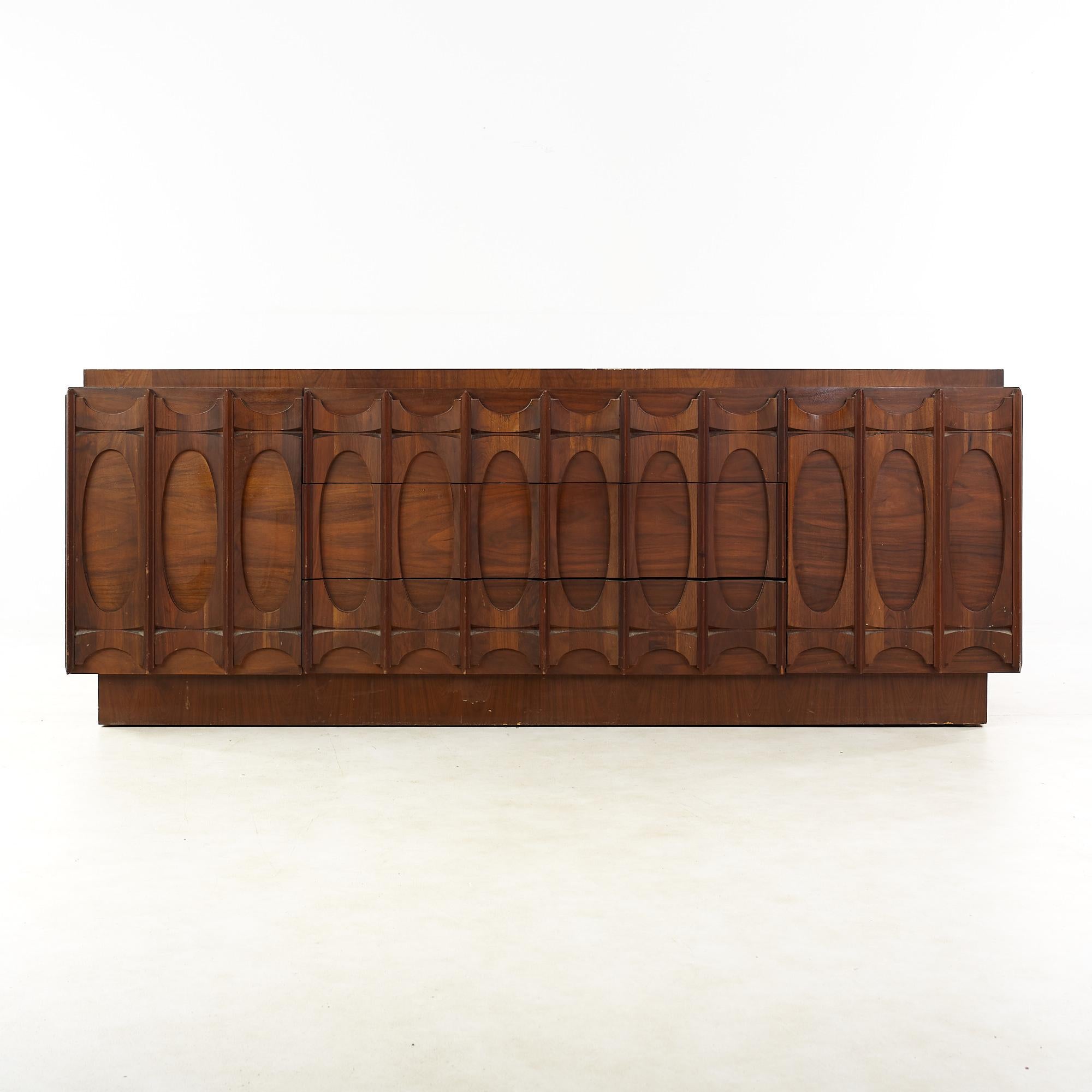 Tobago Brutalist mid-century walnut 9 drawer lowboy dresser.

This dresser measures: 81 wide x 22 deep x 30 inches high.

All pieces of furniture can be had in what we call restored vintage condition. That means the piece is restored upon