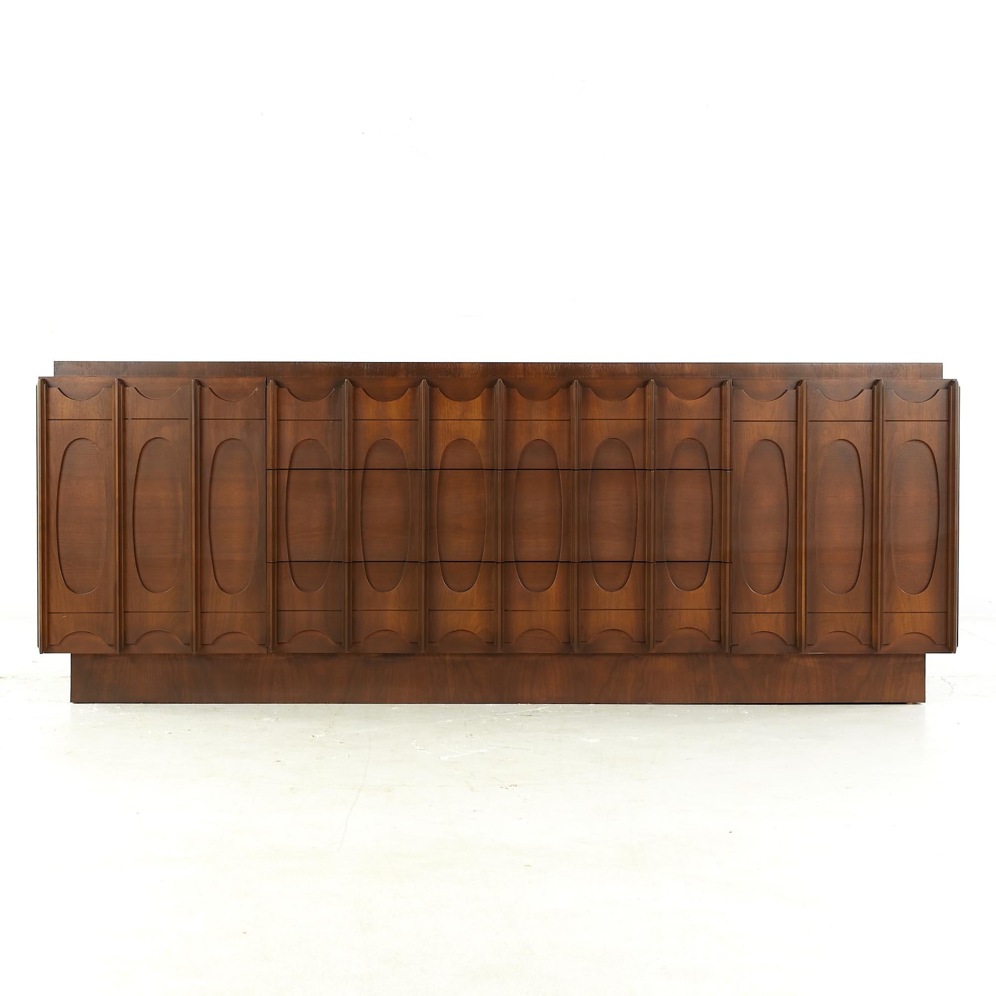 Tobago Brutalist midcentury walnut 9 drawer lowboy dresser.

Dresser measures: 80 wide x 21.5 deep x 30.5 inches high

All pieces of furniture can be had in what we call restored vintage condition. That means the piece is restored upon purchase