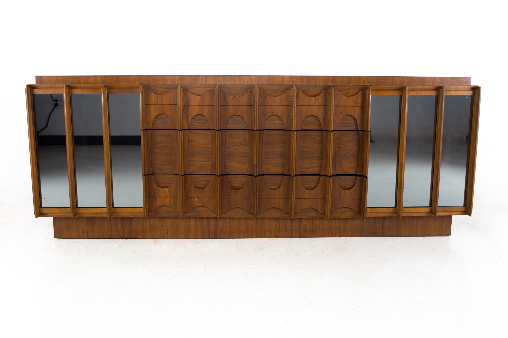 Tobago Brutalist mid century walnut and mirror 9 drawer lowboy dresser
Dresser measures: 80.25 wide x 21.75 deep x 30.5 inches high

All pieces of furniture can be had in what we call restored vintage condition. That means the piece is restored