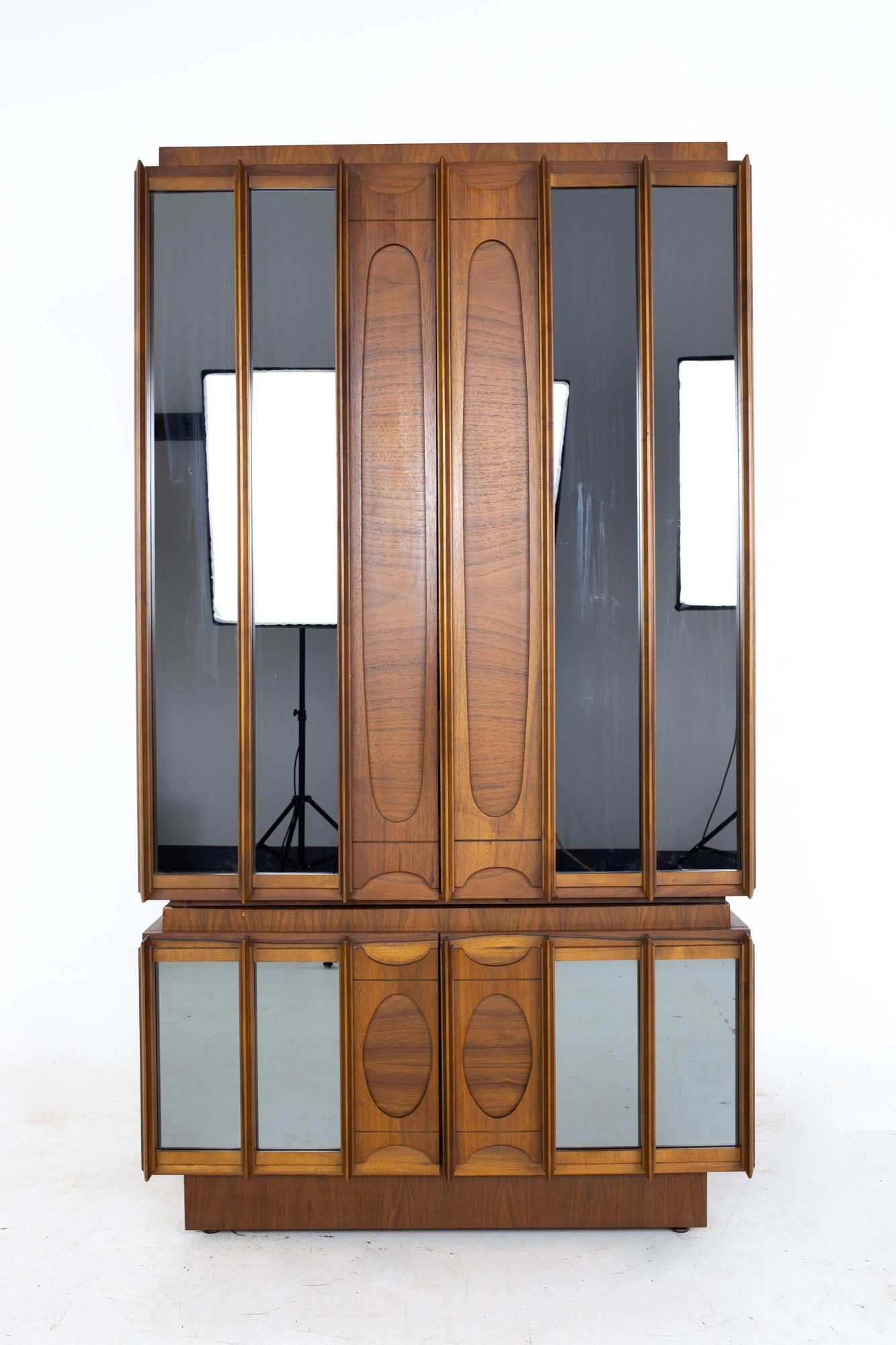 Tobago Brutalist mid century walnut and mirror armoire
Armoire measures: 40 wide x 21.75 deep x 73 inches high

All pieces of furniture can be had in what we call restored vintage condition. That means the piece is restored upon purchase so it’s