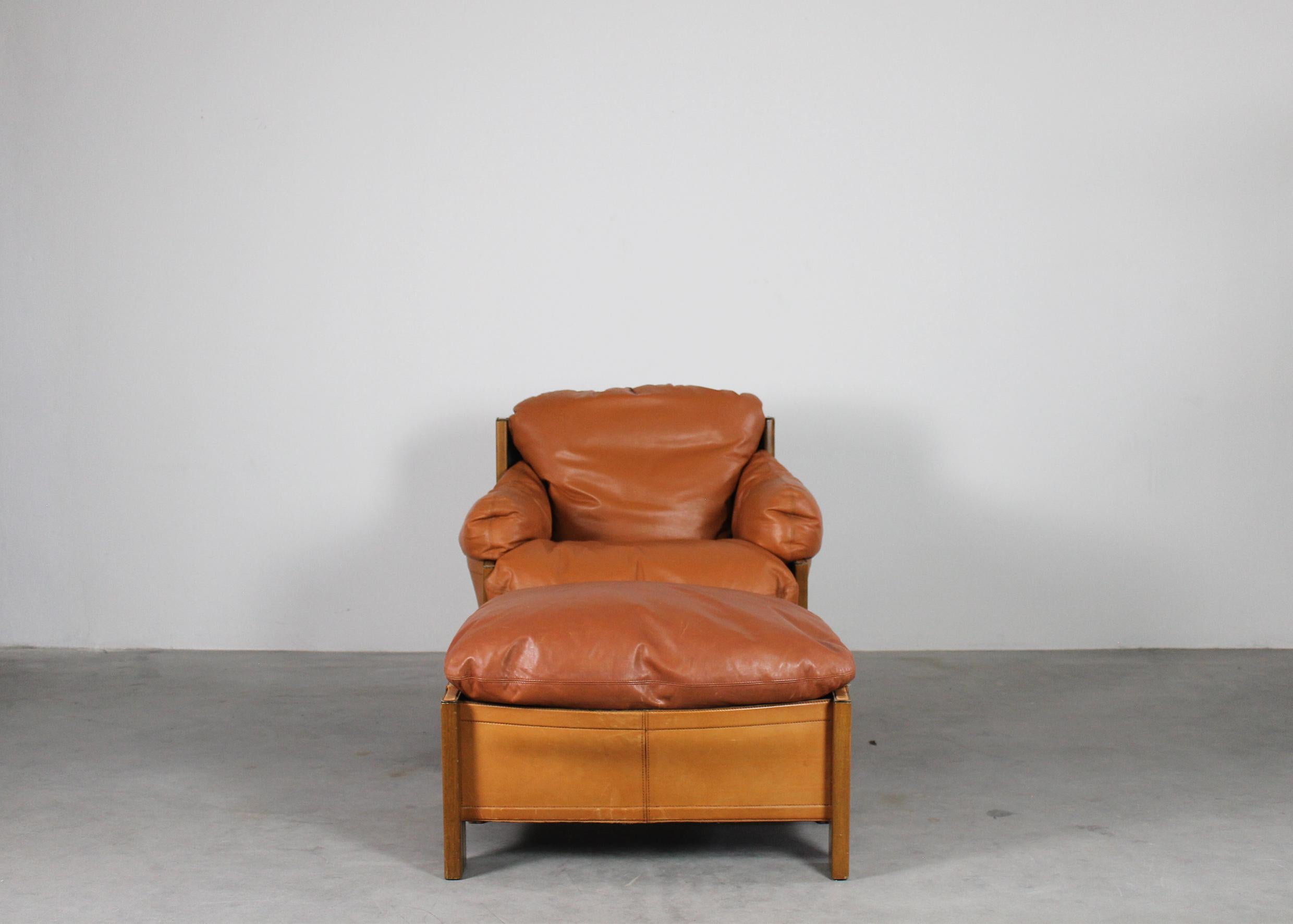A set with an armchair and footrest with a frame in wood and upholstery in cognac leather, designed by Tobia and Afra Scarpa and manufactured by Maxalto from the Artona series 1975 ca. 

Tobia Scarpa and his wife Afra Bianchin began their long