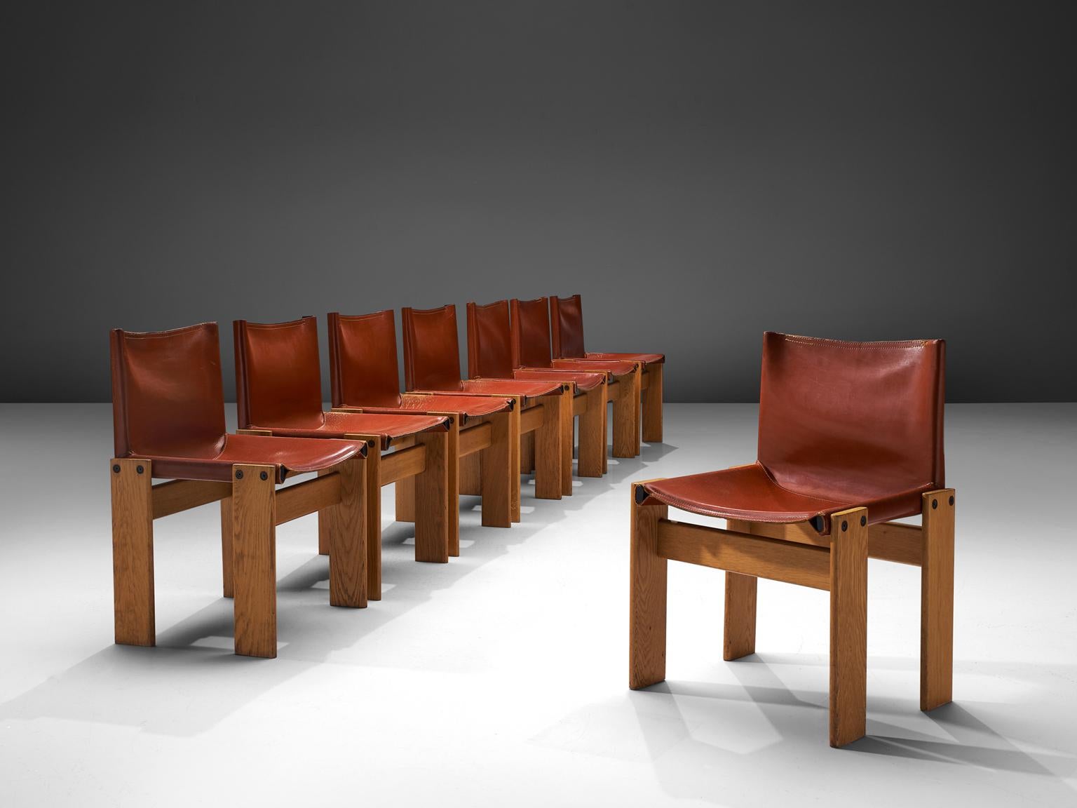 Afra & Tobia Scarpa for Molteni, monk set of eight dining chairs, patinated beech and terracotta leather, Italy, 1974.

The wonderfully warm red leather forms a striking combination with the blond wood. Interesting is the 'flat' shape of this