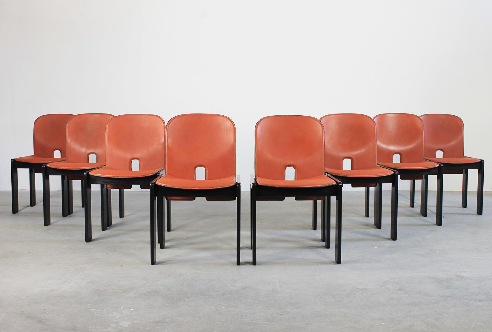 Set of eight 121 chairs with structure in black lacquered wood, seat and back in leather designed by Tobia and Afra Scarpa and manufactured by Cassina in 1965.

A few chairs present the original Cassina's label under the seat.

Tobia Scarpa and his