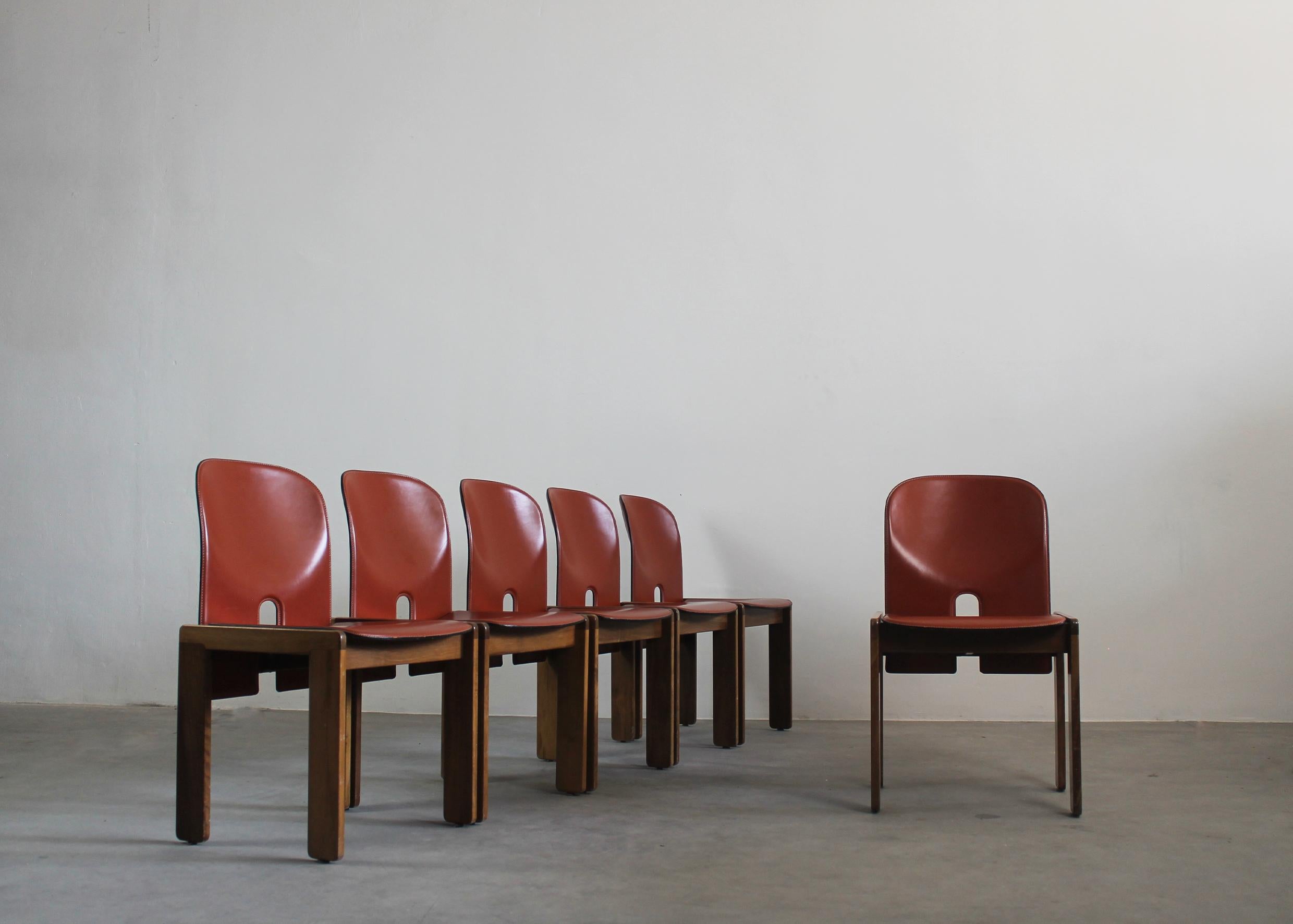 Set of six 121 dining chairs with walnut wooden frames and plywood, seats and backs covered with cognac shade leather

Designed by Afra e Tobia Scarpa and manufactured by Cassina, Italy 1960 ca.

Tobia Scarpa and his wife Afra Bianchin began