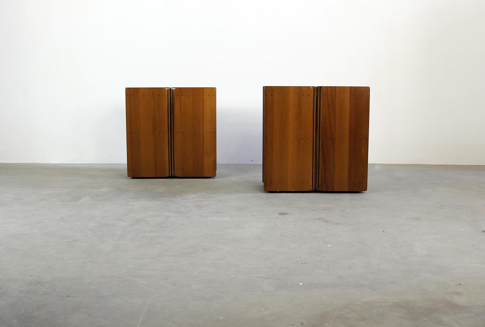 A couple of Artona nightstands in walnut wood and metal details. 
Designed by Tobia and Afra Scarpa and produced by Maxalto in 1970s. 

The night stands reflect on the wood structure the peculiar decorative motif of the Artona serie by Maxalto ,the