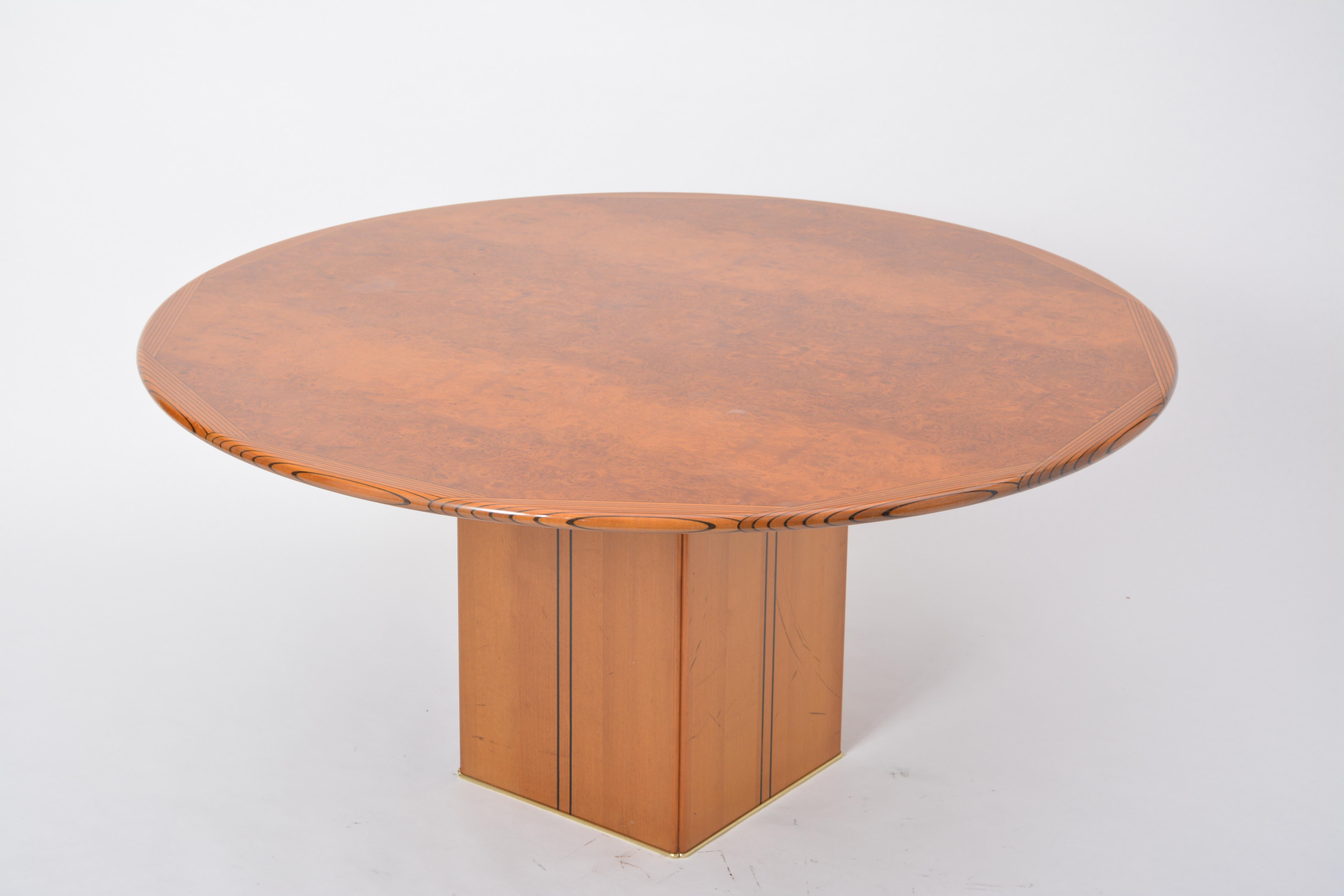 This dining table was designed in 1975 by Afra & Tobia Scarpa for Maxalto a division of B & B Italia. The tabletop is made of burl wood and features walnut with ebony inlay on the edges.
 