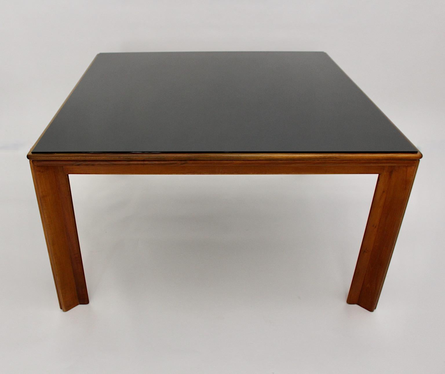 Modernist vintage dining table or center table from walnut and black glass designed by Afra & Tobia Scarpa 1970s Italy.
A beautiful dining table with a blonde walnut frame and the black glass top.
The plate is topped with a black glass plate, while